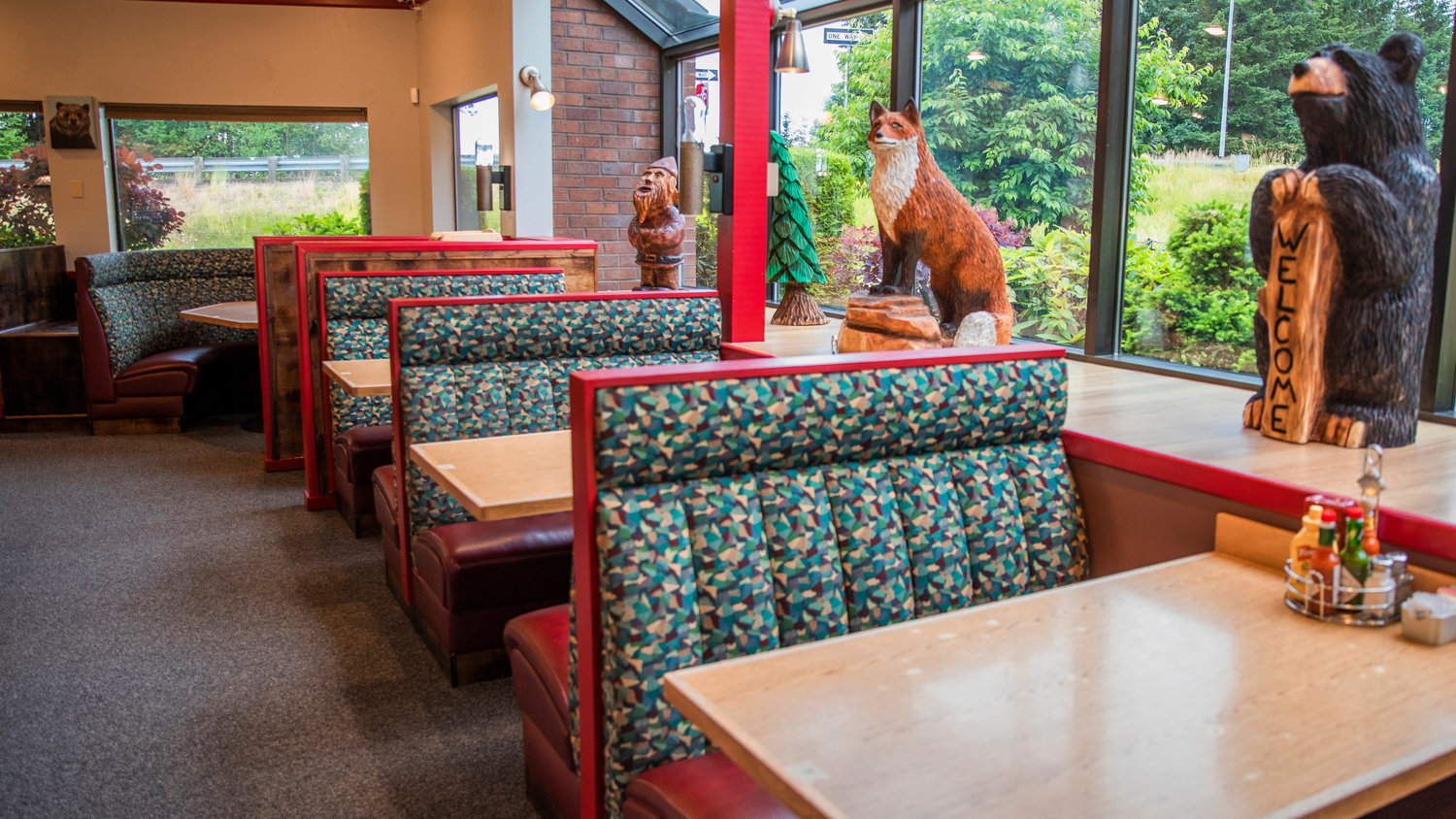 Wooden statues decorate the interior of Papa Bears West Tuesday morning on opening day.
