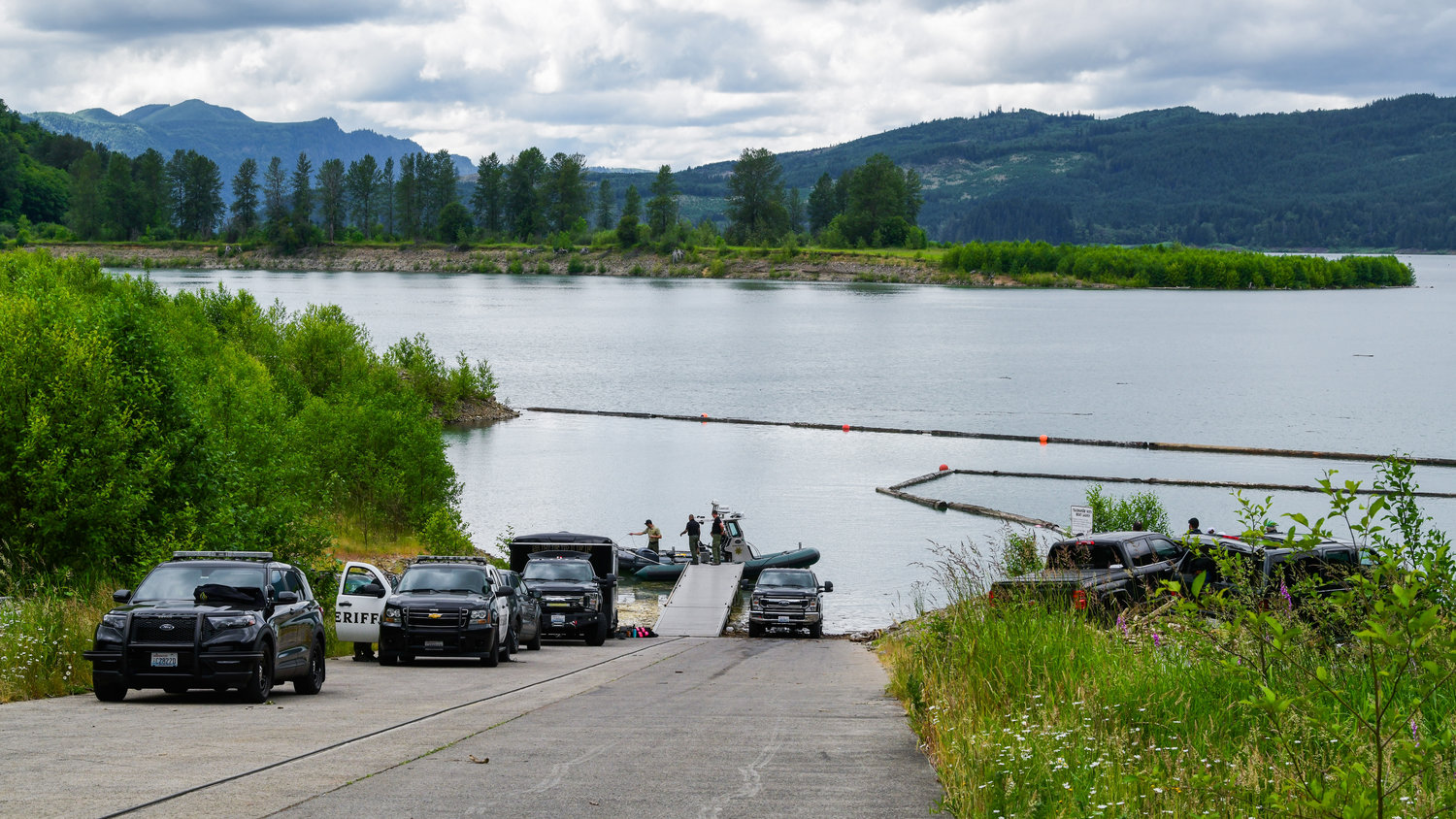 Lewis County Sheriff's Office deputies and the Thurston County Dive Team wrap up a search after making a recovery near the Taidnapam North Boat Launch in Glenoma.