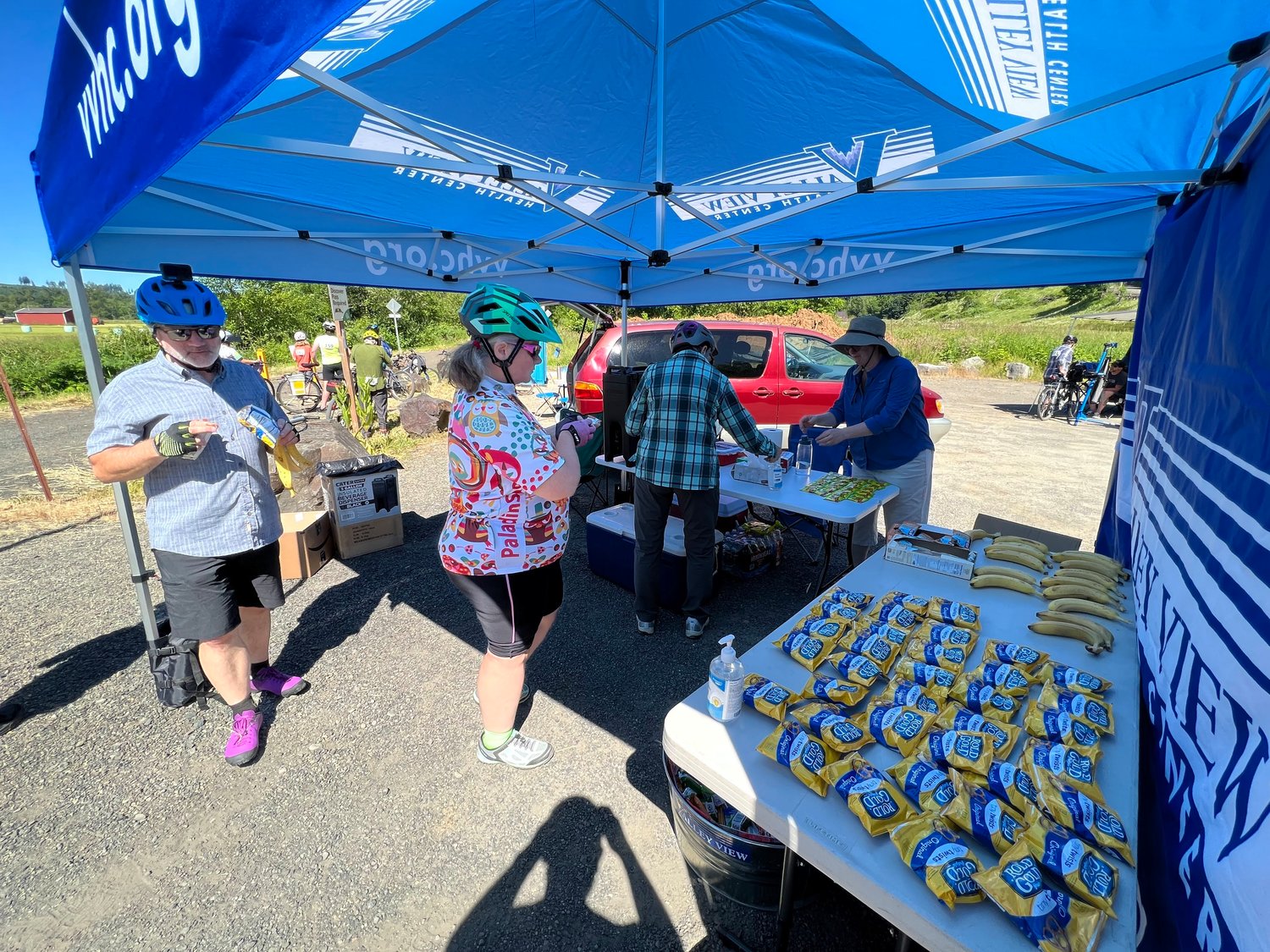 Staff with Valley View Health Center serve riders at the Ceres Hill Trailhead rest stop on Saturday, June 22.