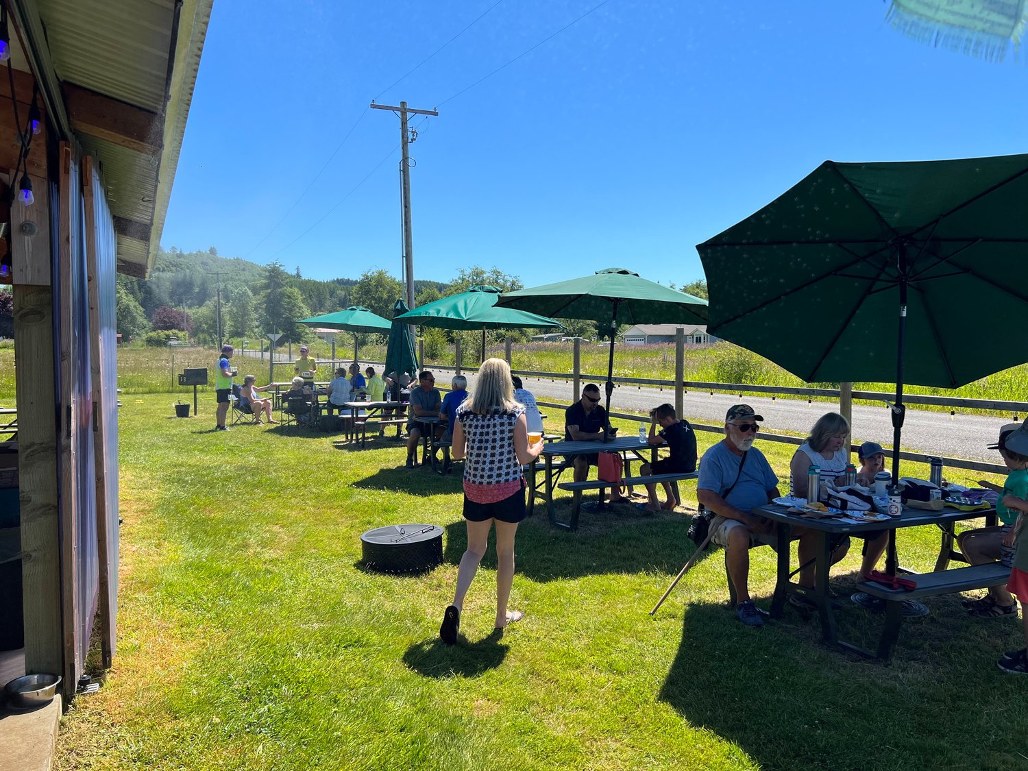 Cyclists and members of the public eat lunch at Jones Creek Brewing in Pe Ell. Jones Creek served as a rest stop for the ride and also hosted a pop-up market.