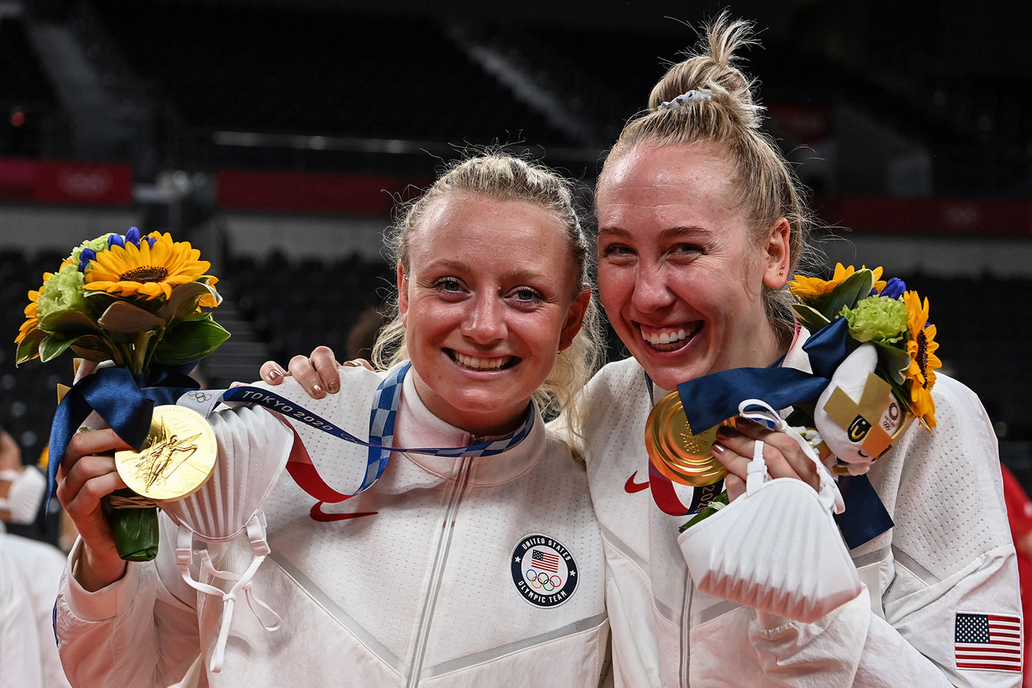 From left to right: USA's Jordyn Poulter and Michelle Bartsch-Hackley pose with their gold medals during the women's volleyball victory ceremony during the Tokyo 2020 Olympic Games at Ariake Arena in Tokyo on Aug. 8, 2021. (Yuri Cortez/AFP via Getty Images/TNS)