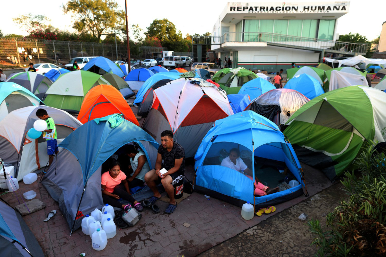 Migrants from Central America and Mexico await the outcome of their U.S. immigration court cases in a tent encampment near the Gateway International Bridge at the U.S.-Mexico border in Matamoros, Tamaulipas, on Oct. 1, 2019. (Gary Coronado/Los Angeles Times/TNS)