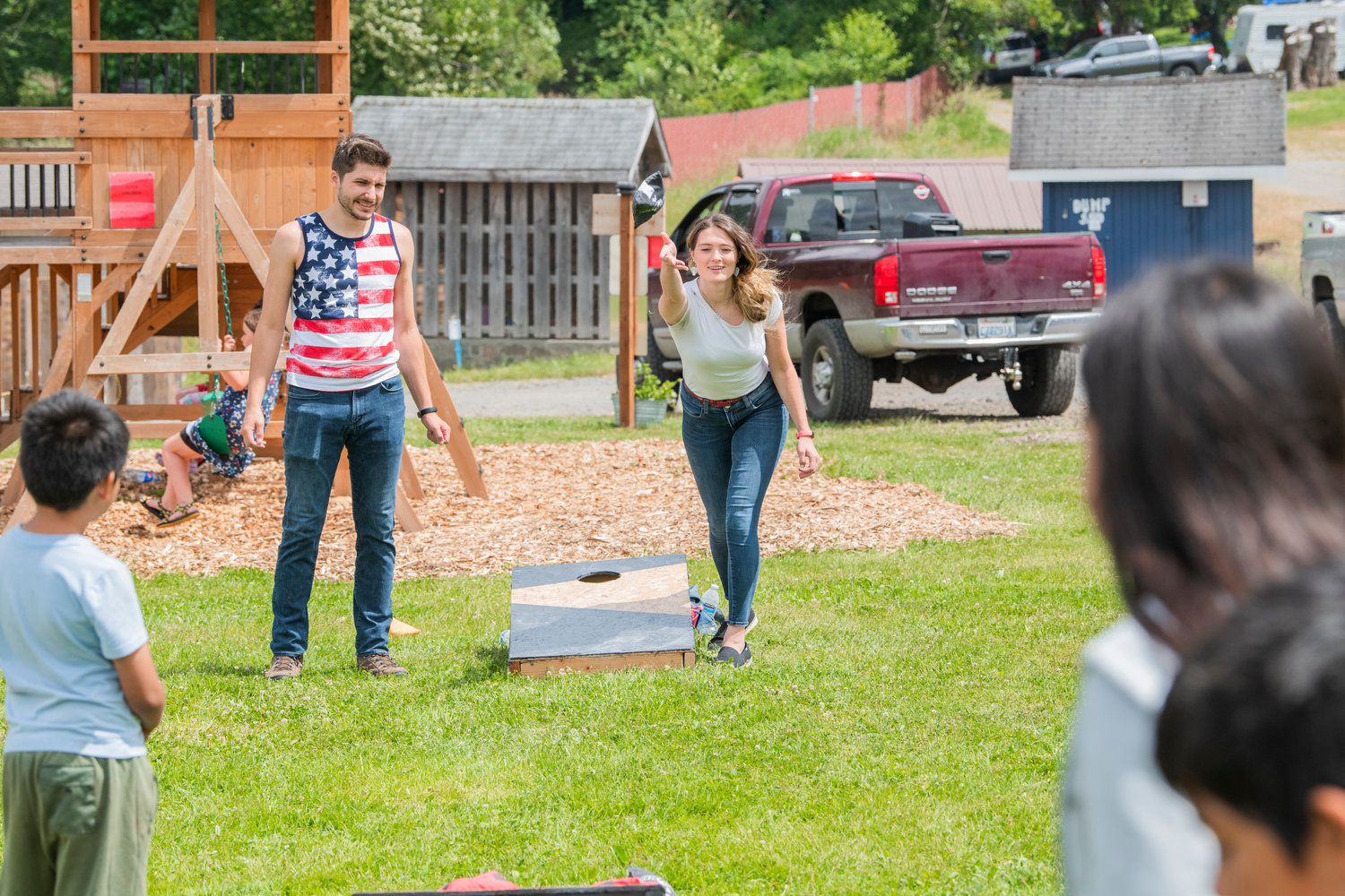 Shane and Lauren Welter smile while playing cornhole at the Lions Den Campground before performing music together as “Shore Lane” Saturday in Mineral.