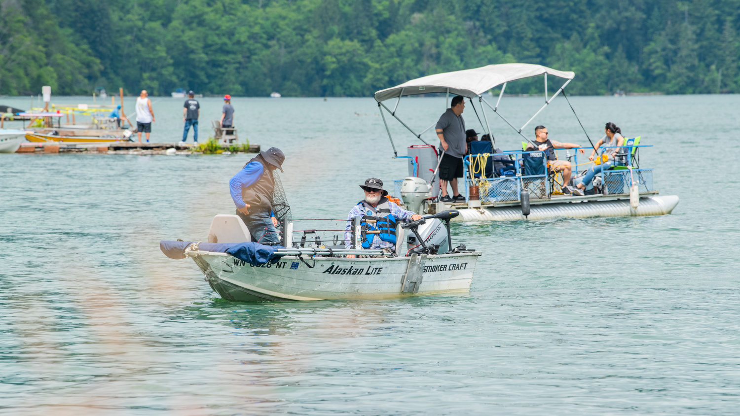 Boaters bask in the sun as visitors fish at Mineral Lake on Saturday