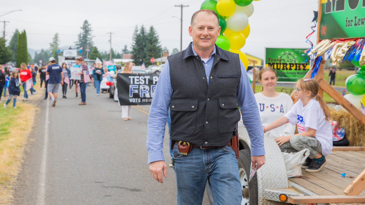 Lewis County sheriff candidate Tracy Murphy smiles while walking in the Mossyrock Freedom Festival parade on Saturday.