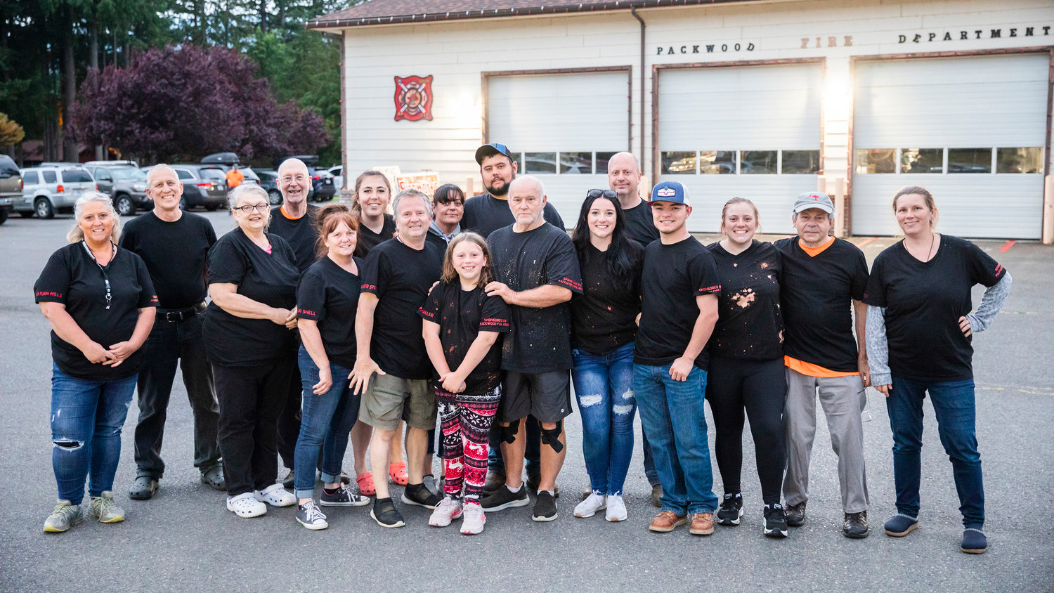 Lonnie Goble, friends, family and volunteers pose for a photo outside the Packwood Fire Department before a firework show Saturday evening.
