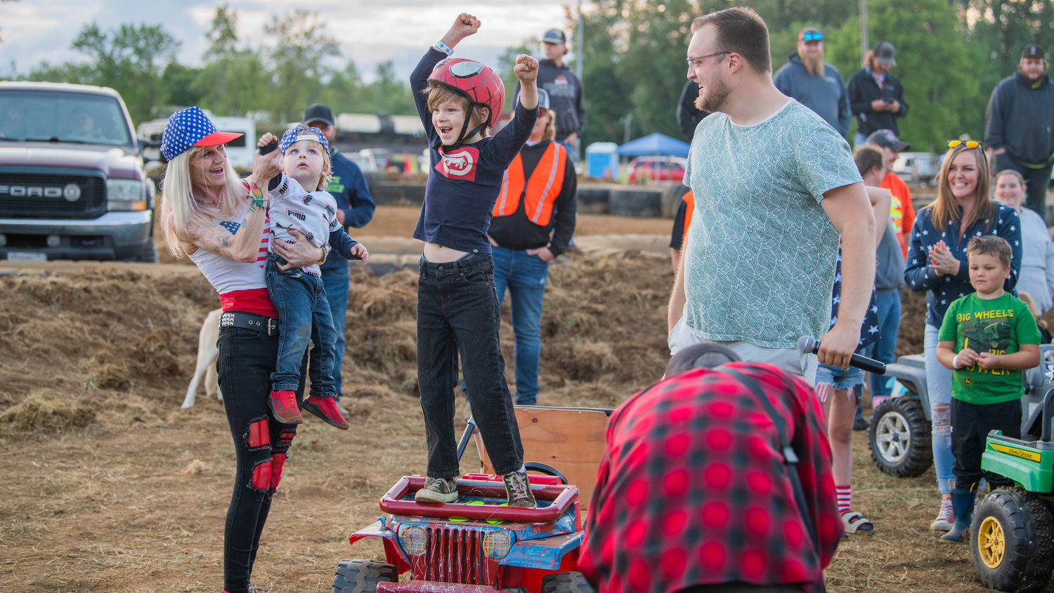 William Arnhold, 7, of Tacoma, cheers after winning the first-ever power wheels demolition derby for kids at the Southwest Washington Fairgrounds Sunday night during Summerfest celebrations.