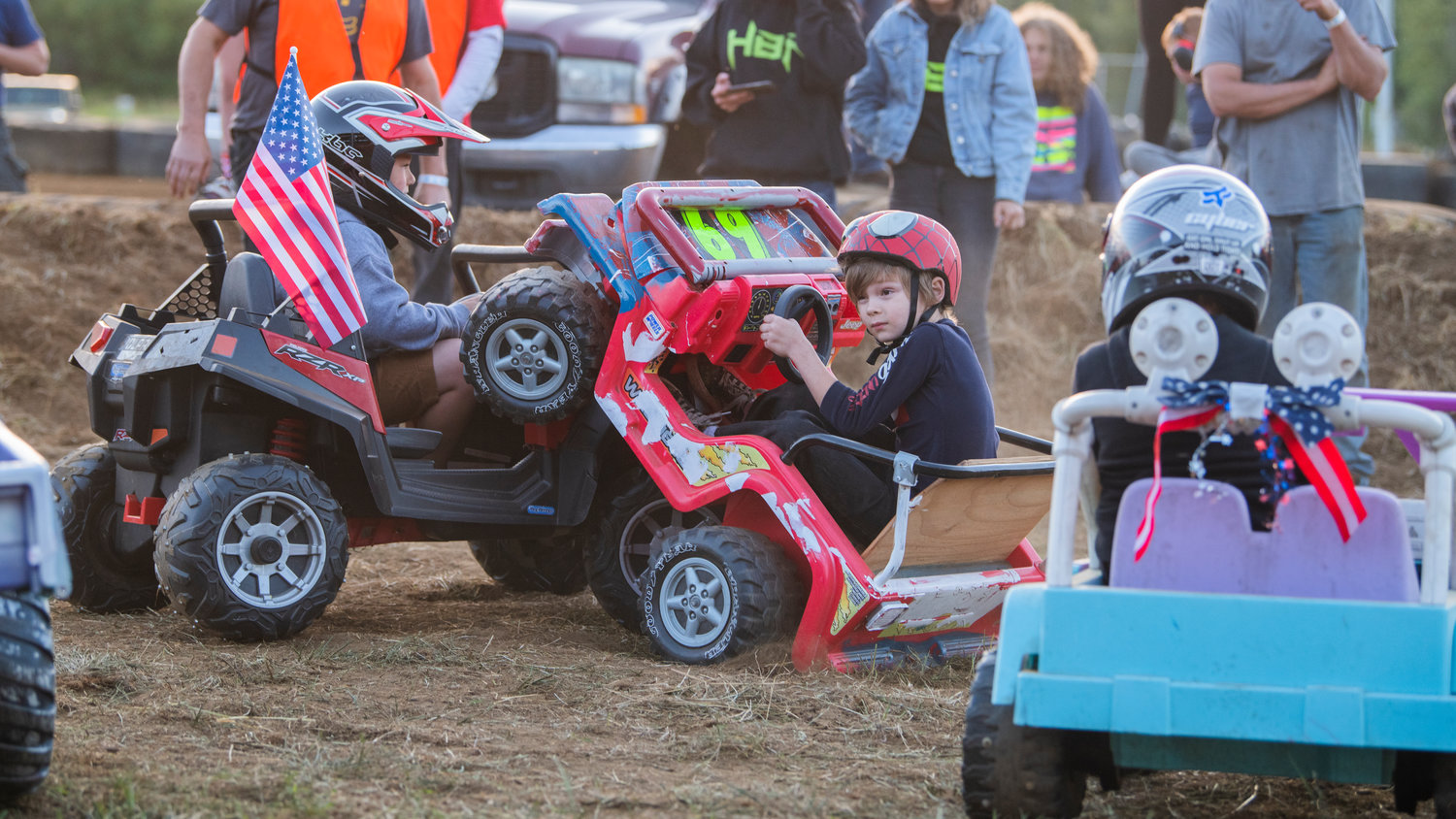 William Arnhold, 7, of Tacoma, wheelies into competition during the first-ever power wheels demolition derby for kids at the Southwest Washington Fairgrounds Sunday night in Centralia.
