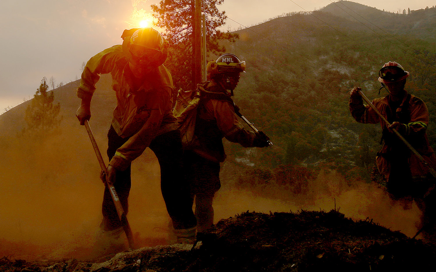 Firefighters put out hotspots from the Oak fire along Darrah Road near Mariposa on Tuesday, July 26, 2022. (Luis Sinco/Los Angeles Times/TNS)
