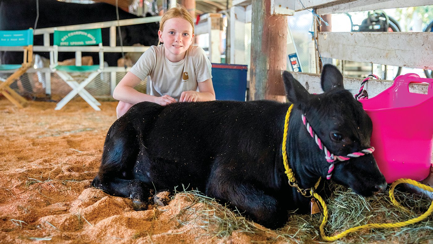 Kyla Watson, 13, of Tenino, smiles for a photo Thursday with Sandy her Angus cow during the Thurston County Fair in Lacey.