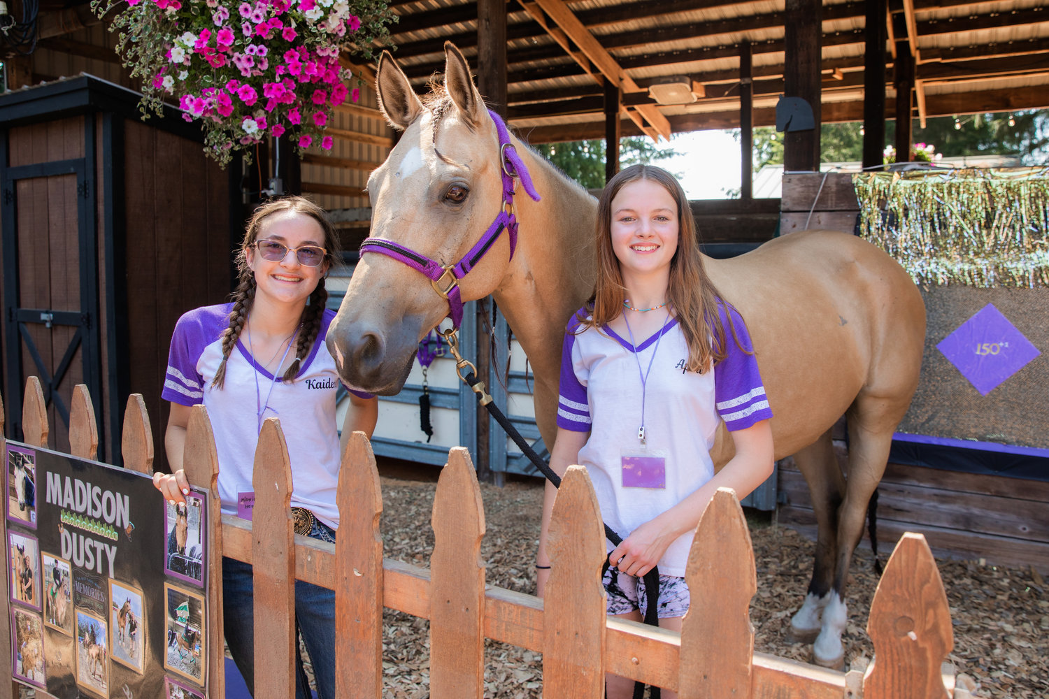 Kaidence Yancey and Anna Mills smile for a photo with Dusty an American Quarter Horse on display at the Thurston County Fair on Thursday.