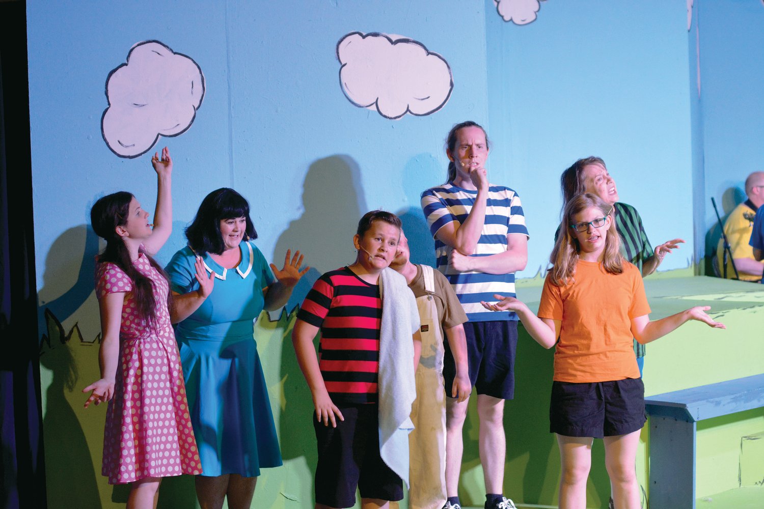The majority of the “You’re a Good Man, Charlie Brown” cast closes in during a performance of the play-titled song.