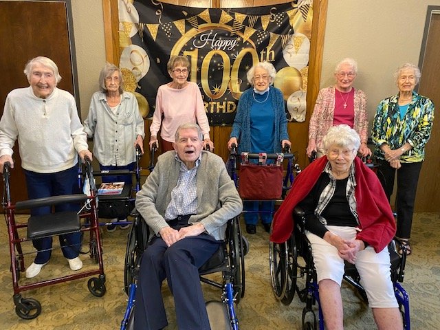 Woodland Village’s eight centenarians. Back, from left to right: Louise Carpenter, 100; Agnes Wasson, 101; Dottie Docherty, 100; Eileen Wikokff, 101; Shirley Nelsen, 101 and Glenna Ralff, 100. Front: Jim Van Ackren (left), 100 and Pearl Miller, 103.