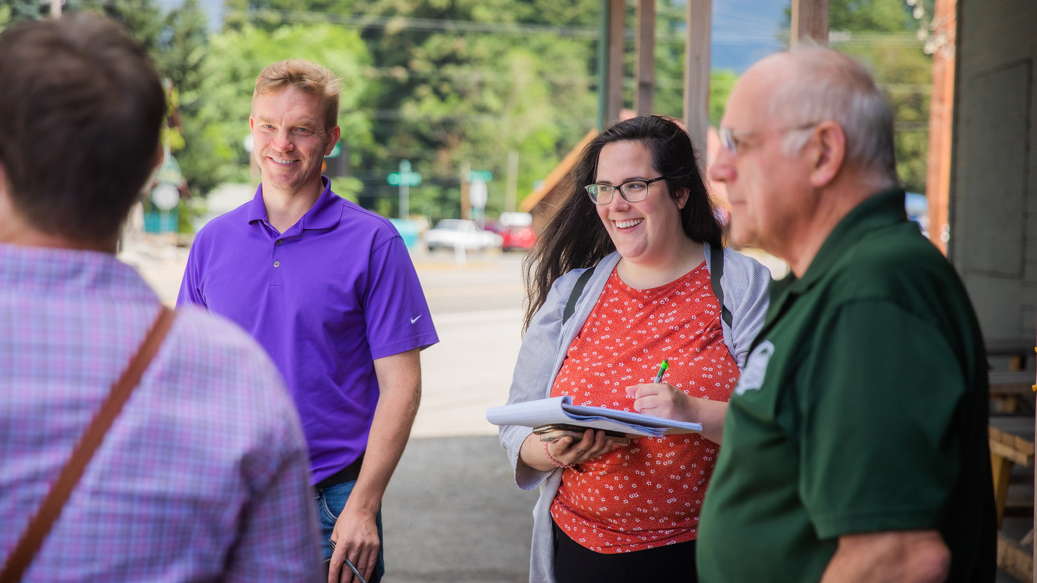 Representatives from U.S. Congresswoman Jamie Herrera Beutler’s and Senator Maria Cantwell’s offices smile while listening to Lewis County Senior Long Range Planner Mindy Brooks and Commissioner Lee Grose talk about tourism and community safety Thursday outside the Packwood Brewing Co.