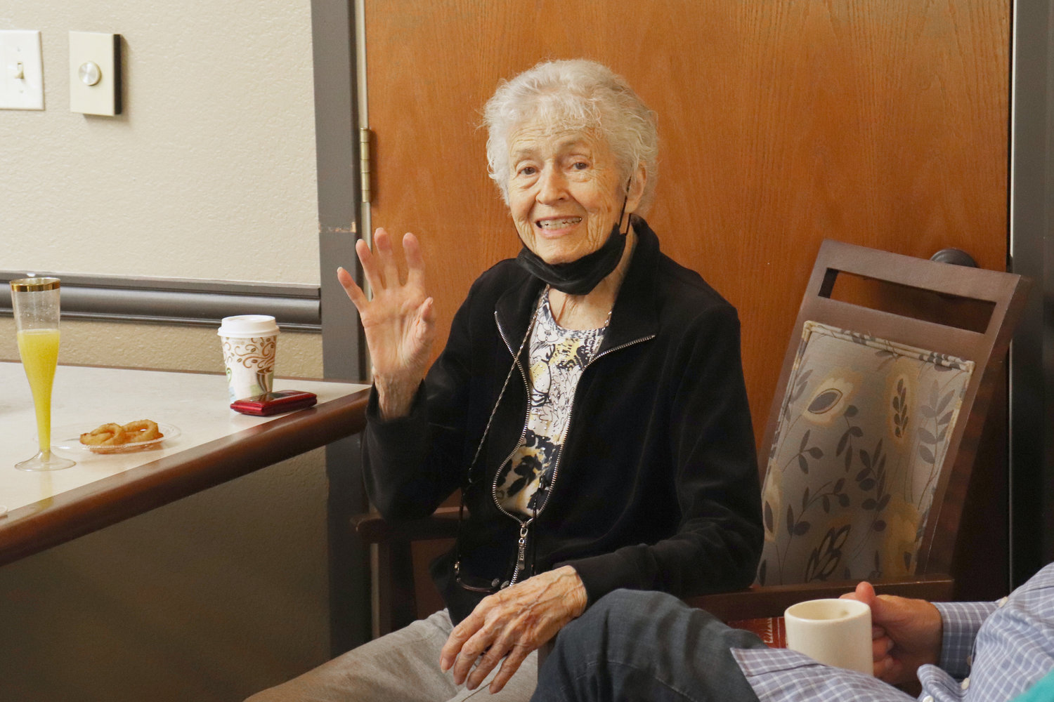 Centenarian Glenna Raiff waves during a celebration at Woodland Village in Chehalis on Monday.