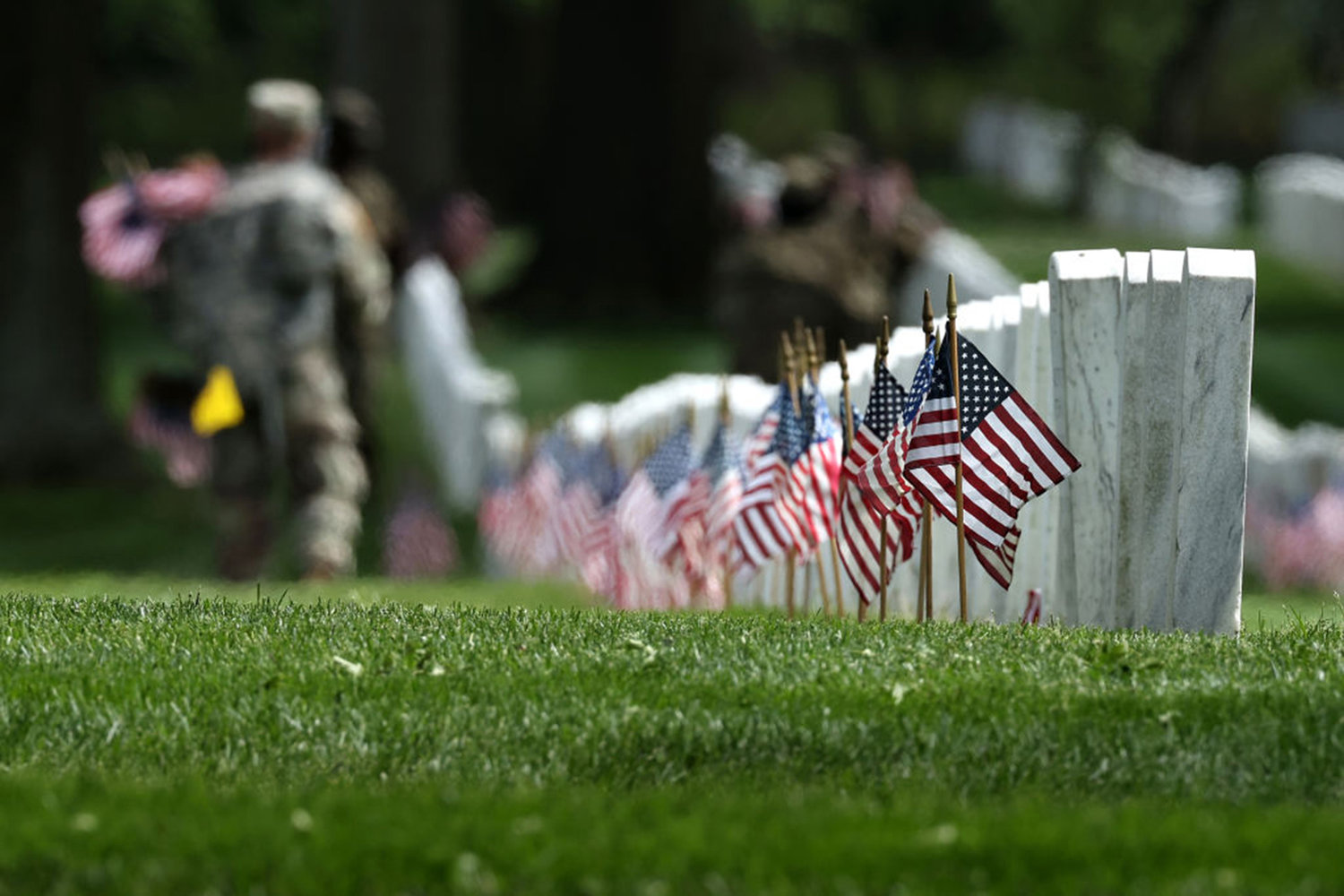 U.S. flags are placed in front of every grave site ahead of Memorial Day weekend in Arlington National Cemetery on May 21, 2020, in Arlington, Virginia. Army Pfc. David Owens, killed in action during World War II, will be buried at Arlington National Cemetery. (Chip Somodevilla/Getty Images/TNS)