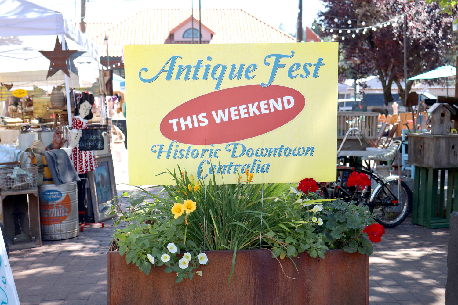 A sign marks the location of Antique Fest in downtown Centralia on Sunday. “Antique, primitive, vintage, farmhouse chic, up cycled, rusty junk — whatever you call it, we have it,” flea market organizers wrote.