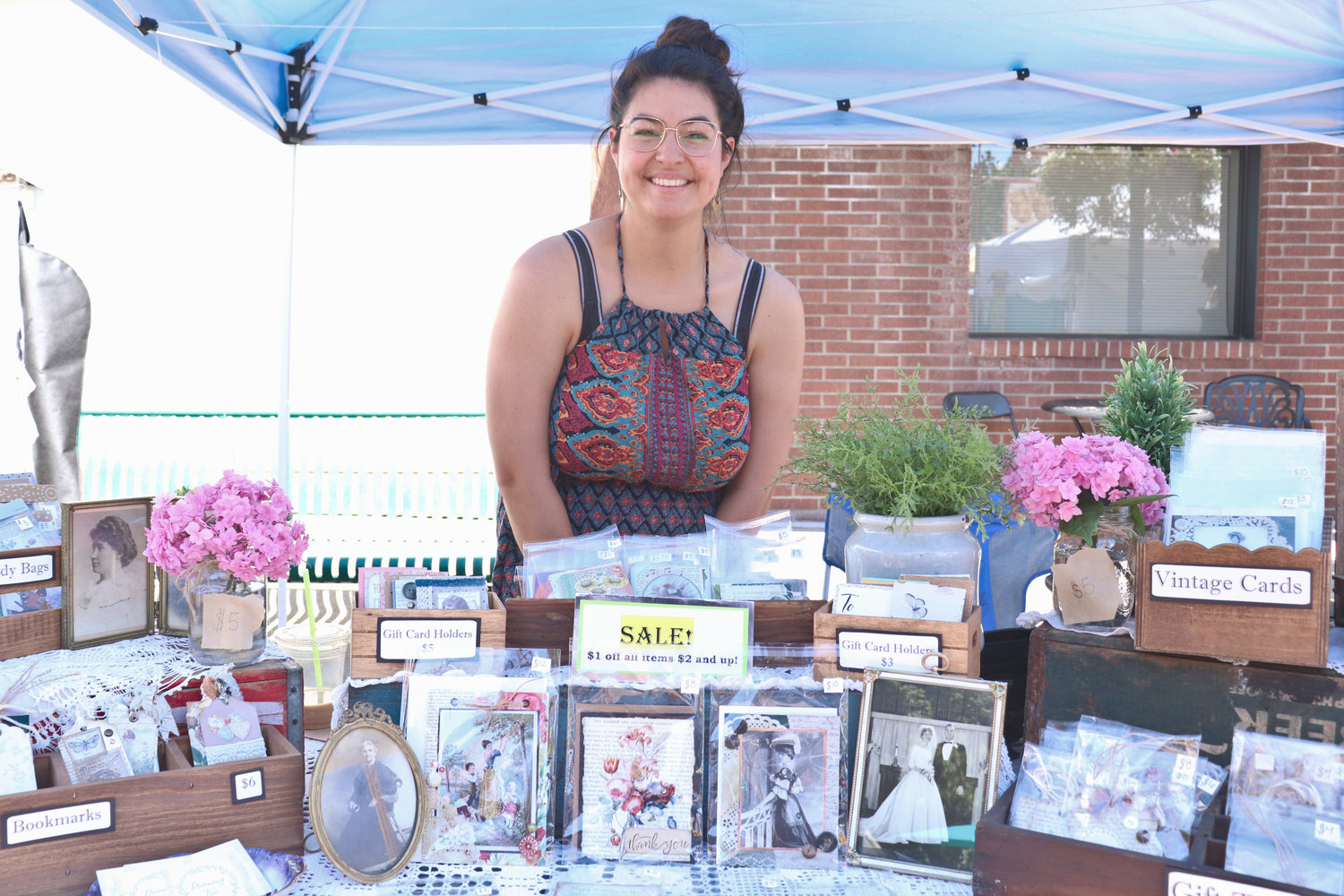 Hobbyist Alaina Osuna of Rainier sells her handmade vintage-inspired cards, bookmarks and other wares at a stall during Antique Fest in downtown Centralia on Sunday.