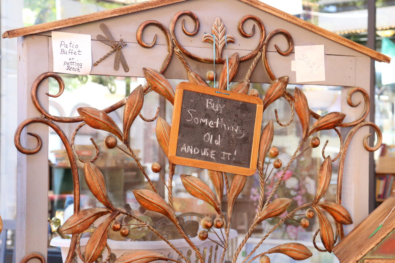 A sign reading “Buy Something Old and Use It!” hangs on a sold “patio buffet or potting bench” at a stall during Antique Fest in downtown Centralia on Sunday.