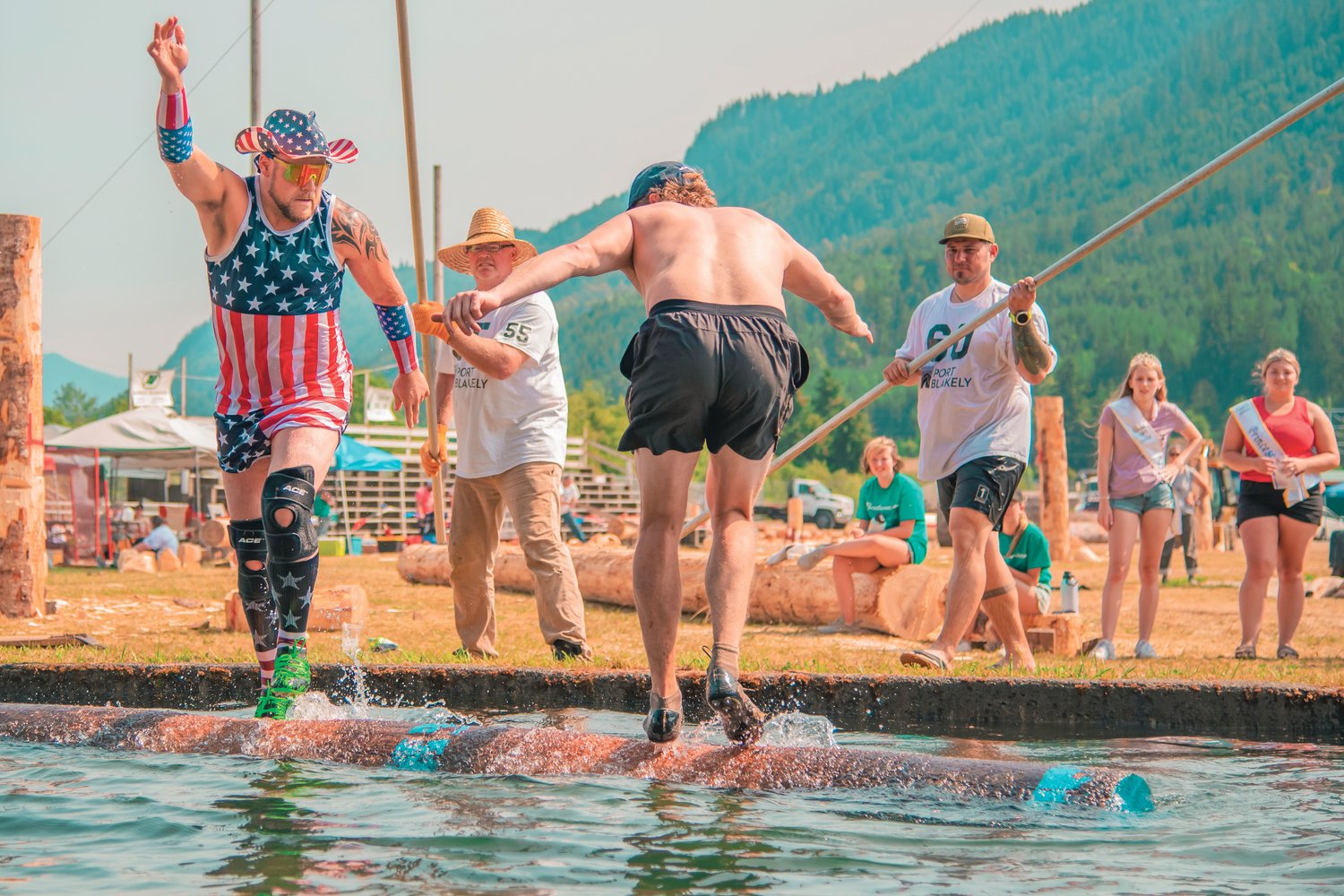 Mike Johnson, far left, and Cassidy Sheer compete for the log rolling championship at the Morton Loggers' Jubilee  in August 2021.