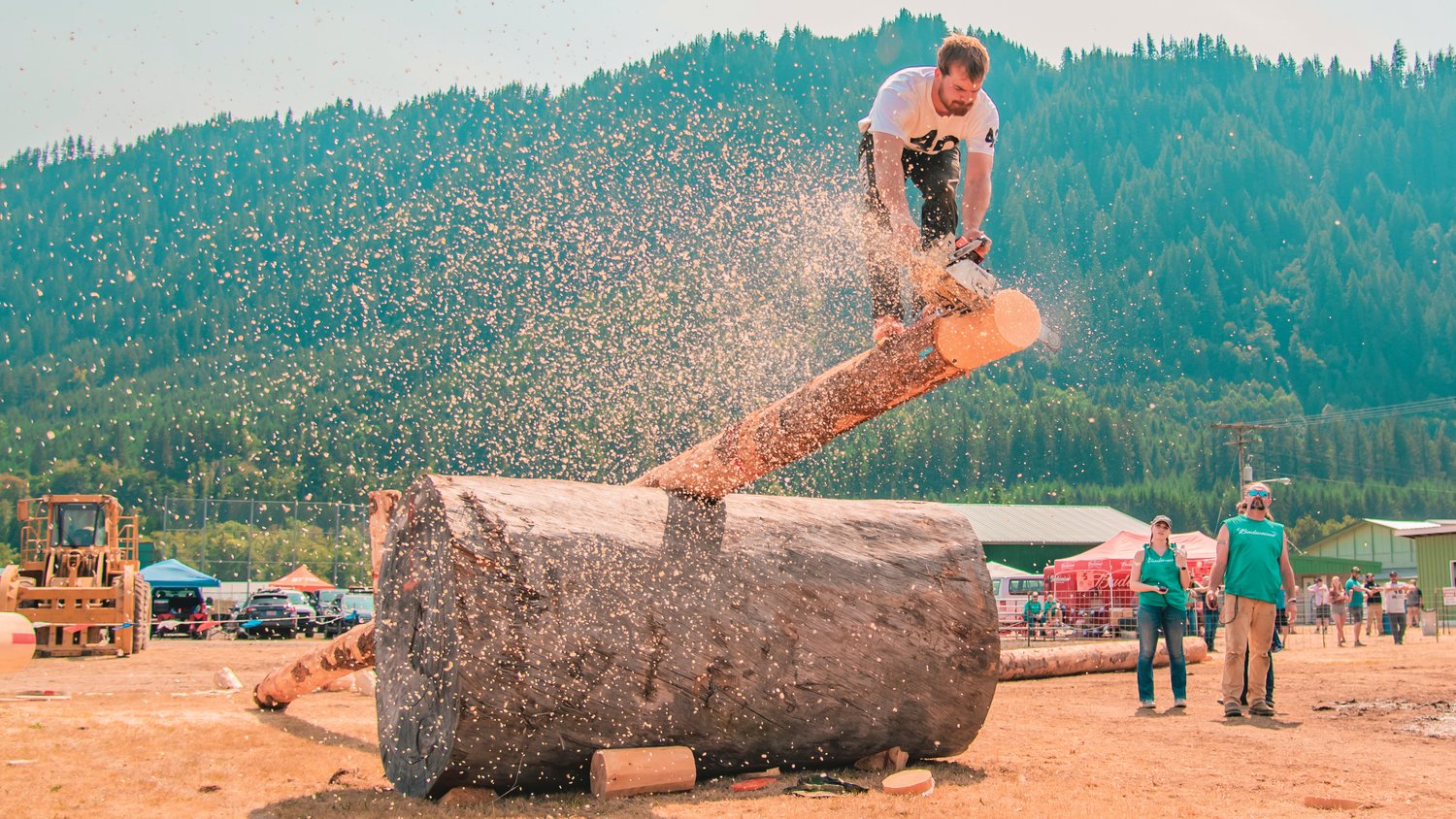 John Parcell uses a chainsaw to saw wood in the obstacle pole event at the Morton Loggers' Jubilee  in August 2021.