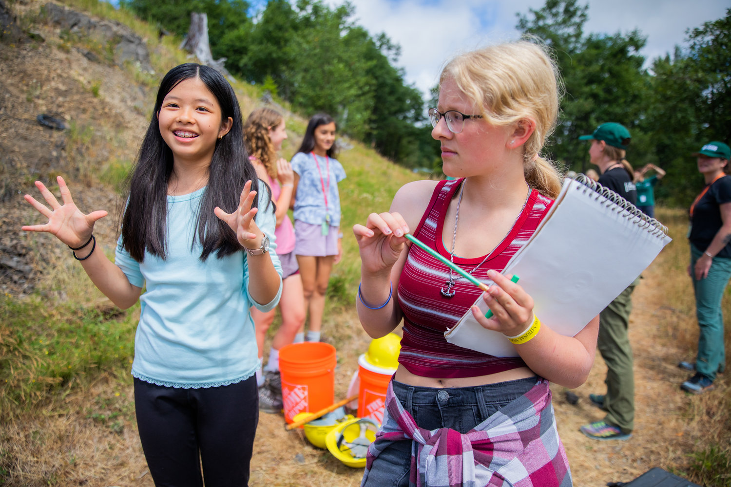 Rainy Wu, 13, of Camas, smiles and talks about connections made during GeoGirls camp at the Mount St. Helens Science and Learning Center at Coldwater alongside Miranda Huibelt.