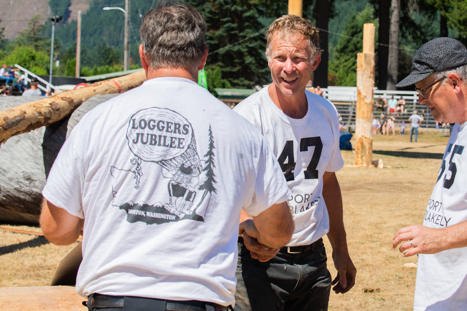 Jeff Skirvin shakes hands with his partner after competing in the double buck event Sunday afternoon inside the Morton Loggers’ Jubilee Arena.