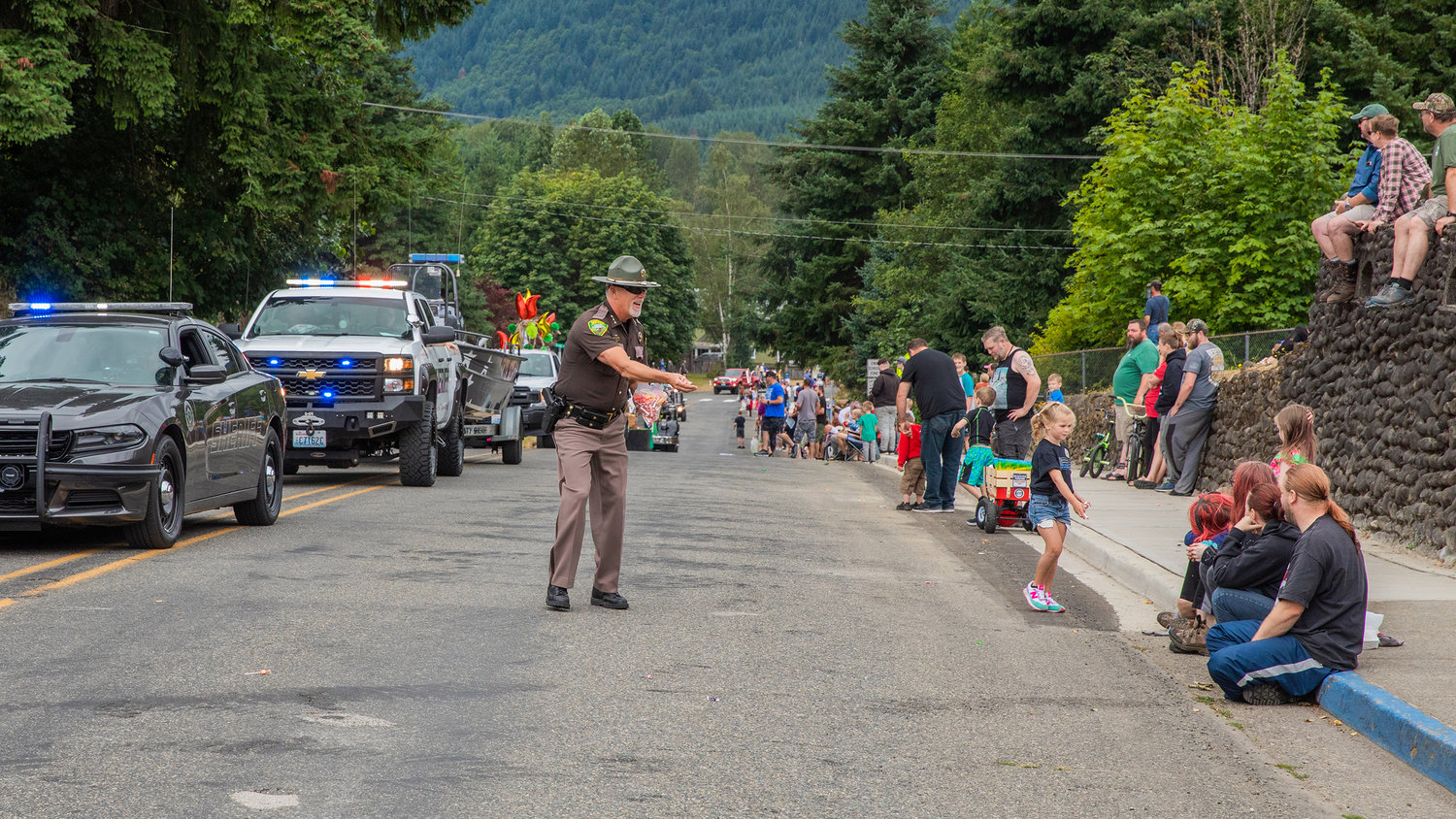 Lewis County Sheriff Rob Snaza throws candy during a parade Saturday in downtown Morton.