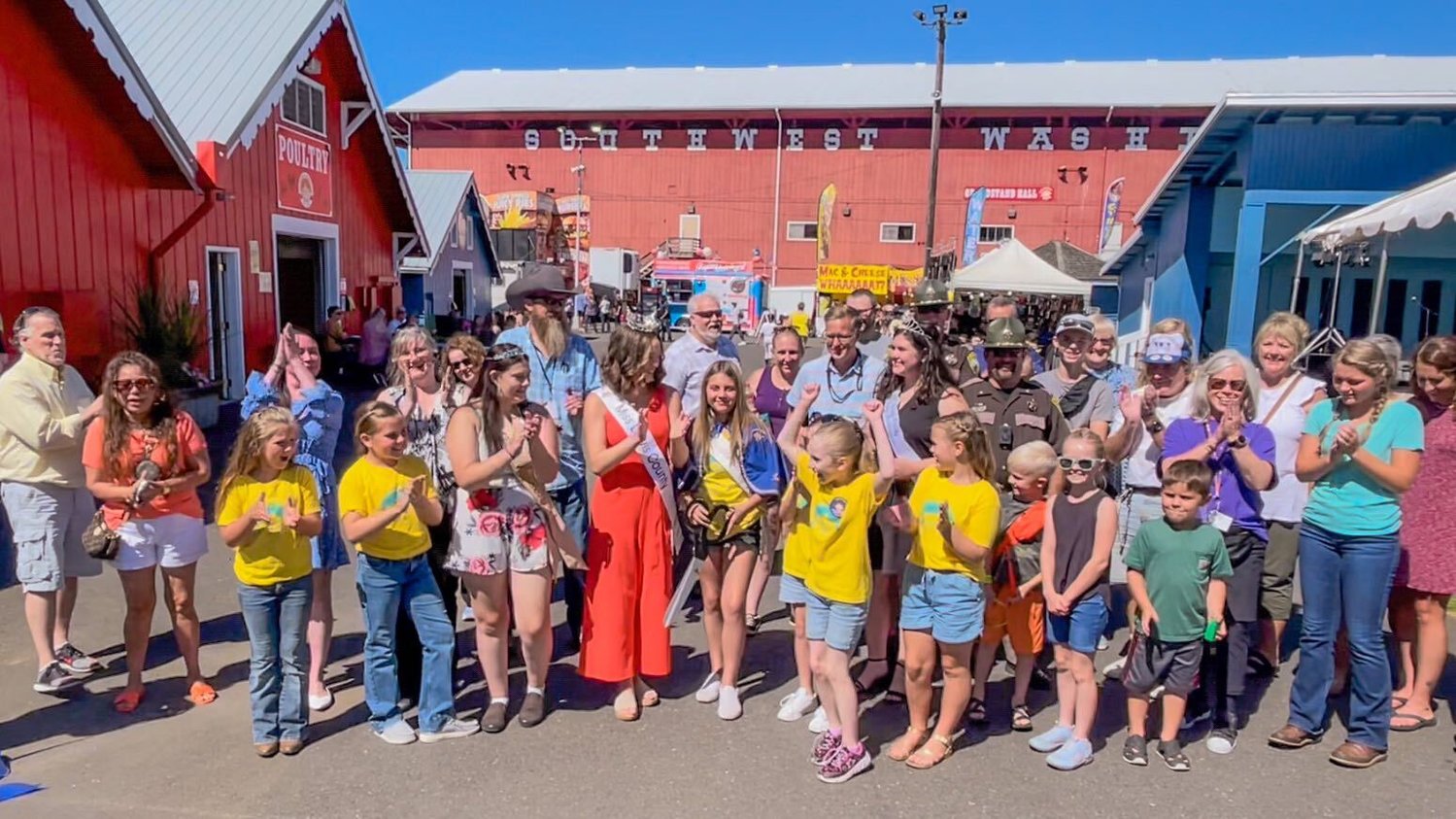 Fair officials, Little Miss Friendly contestants and others cut the ribbon to signify the start of the Southwest Washington Fair Tuesday.