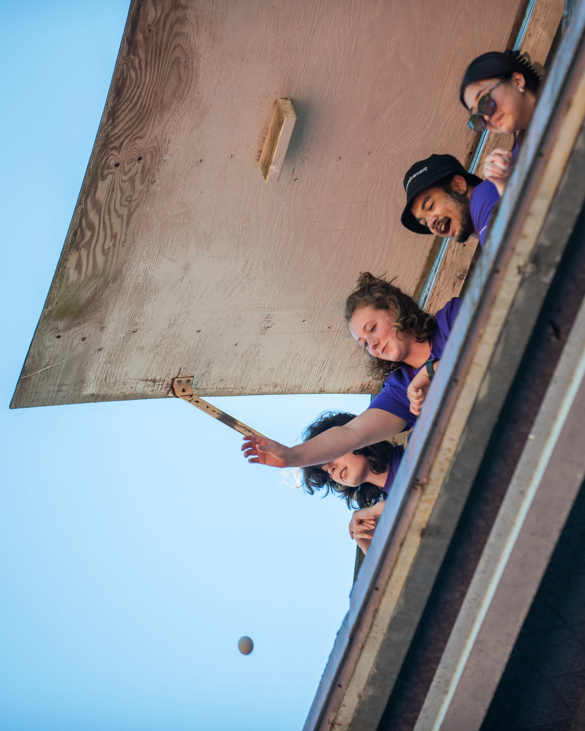 Grace O’Connor, a University of Washington staff member, smiles while dropping eggs from the press box above Bearcat Stadium Tuesday in Chehalis.