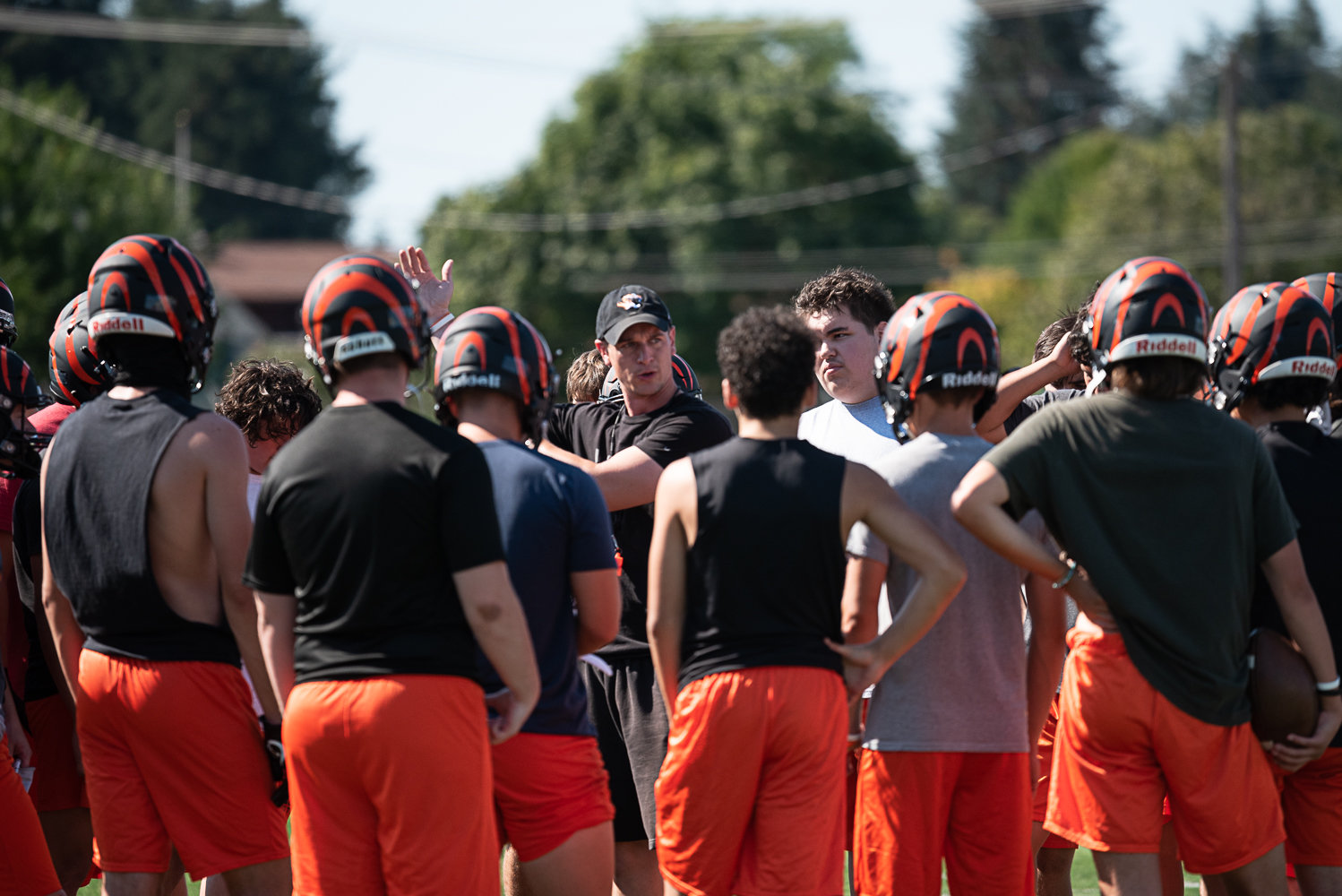 Centralia head coach Dustin McGee talks with his team in a huddle during the first practice of fall camp Aug. 17 at Tiger Stadium.