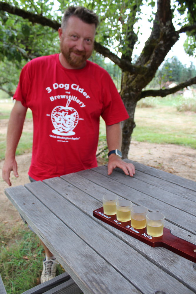 Joshua Hail of 3 Dog Cider & Brewstillery in Silver Creek shows a sample flight of his hard cider.