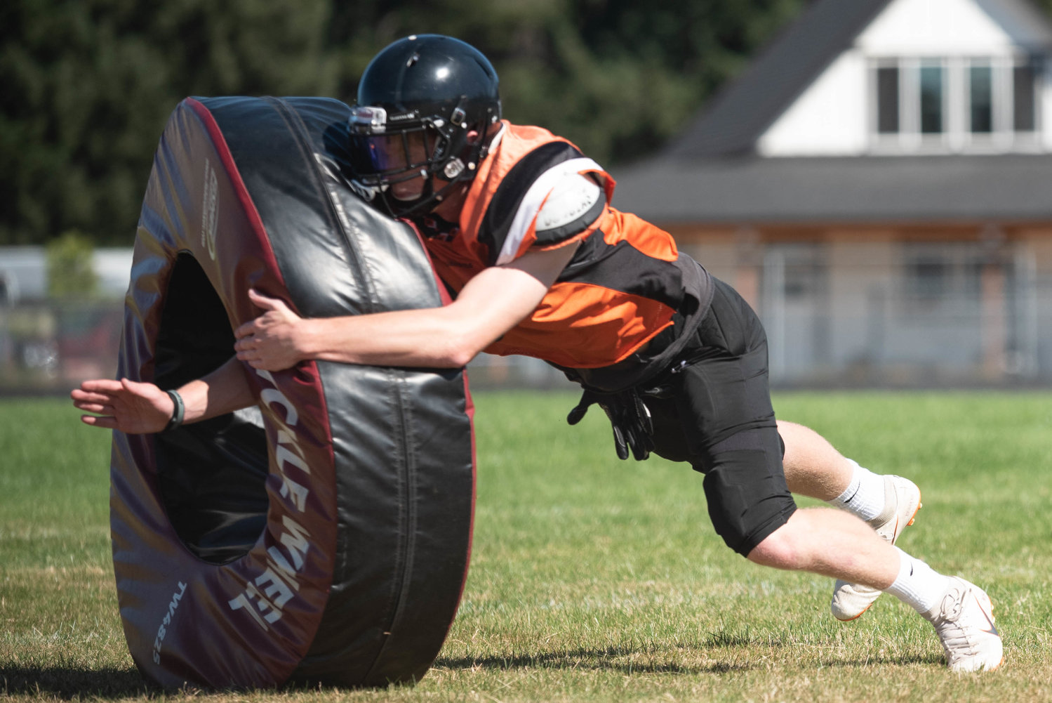 A Rainier player tackles a dummy during a drill Aug. 22.