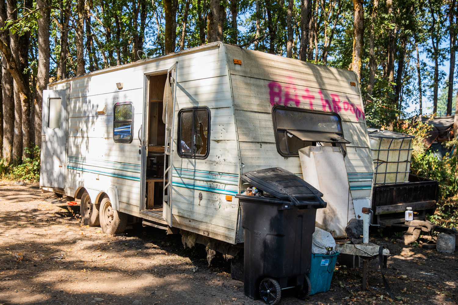 A trailer reads “Bathroom” written in spray paint at a homeless encampment at the end of Eckerson Road in Centralia on Thursday.