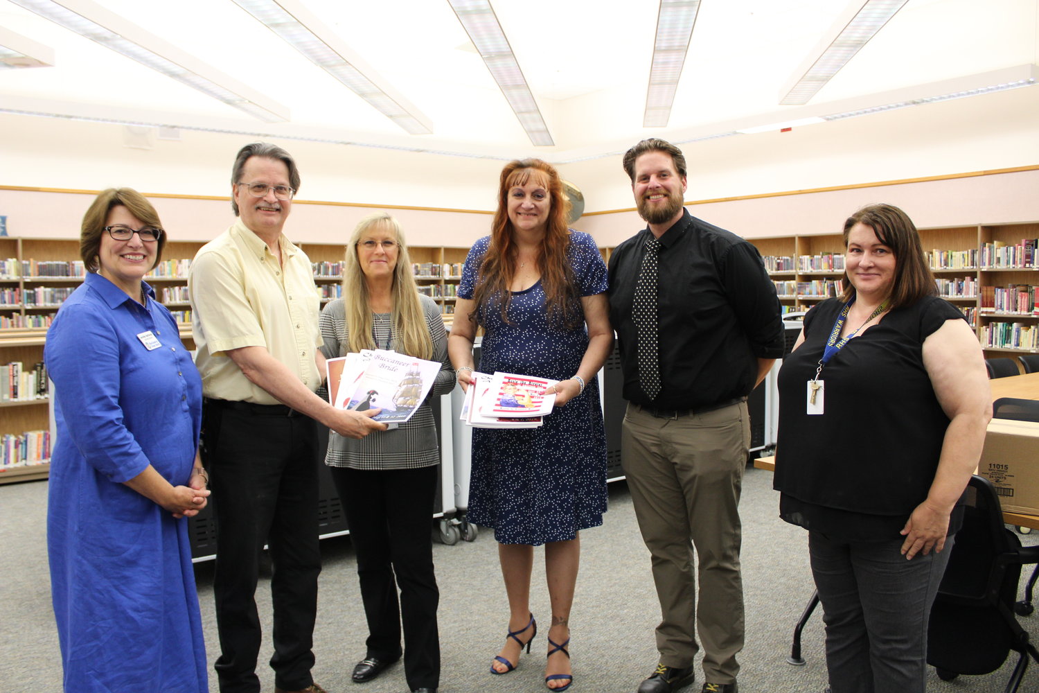 From left to right Rochester School District Superintendent Jennifer Bethman, Rochester High School theater teacher Doug West, RHS librarian Belinda Hollander, Elizabeth West, RHS Principal Michael Smith and RHS Vice Principal Heather Brooks in the RHS library. Doug and Elizabeth West presented the administrators with bound copies of original theater scripts written by Elizabeth West.