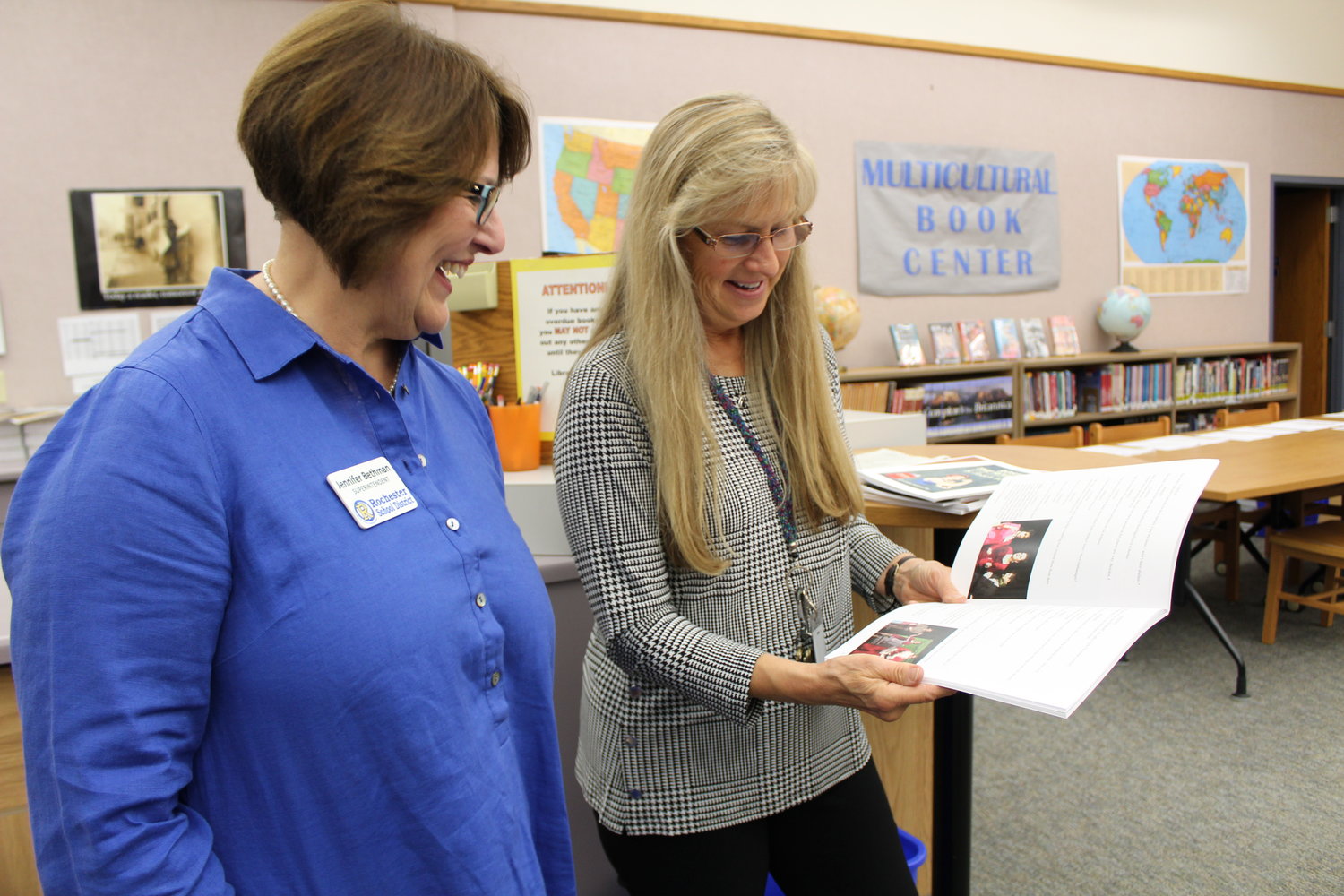 Rochester School District Superintendent Jennifer Bethman and librarian Belinda Hollander look through the donated scripts, which include photos from their productions at Rochester High School.