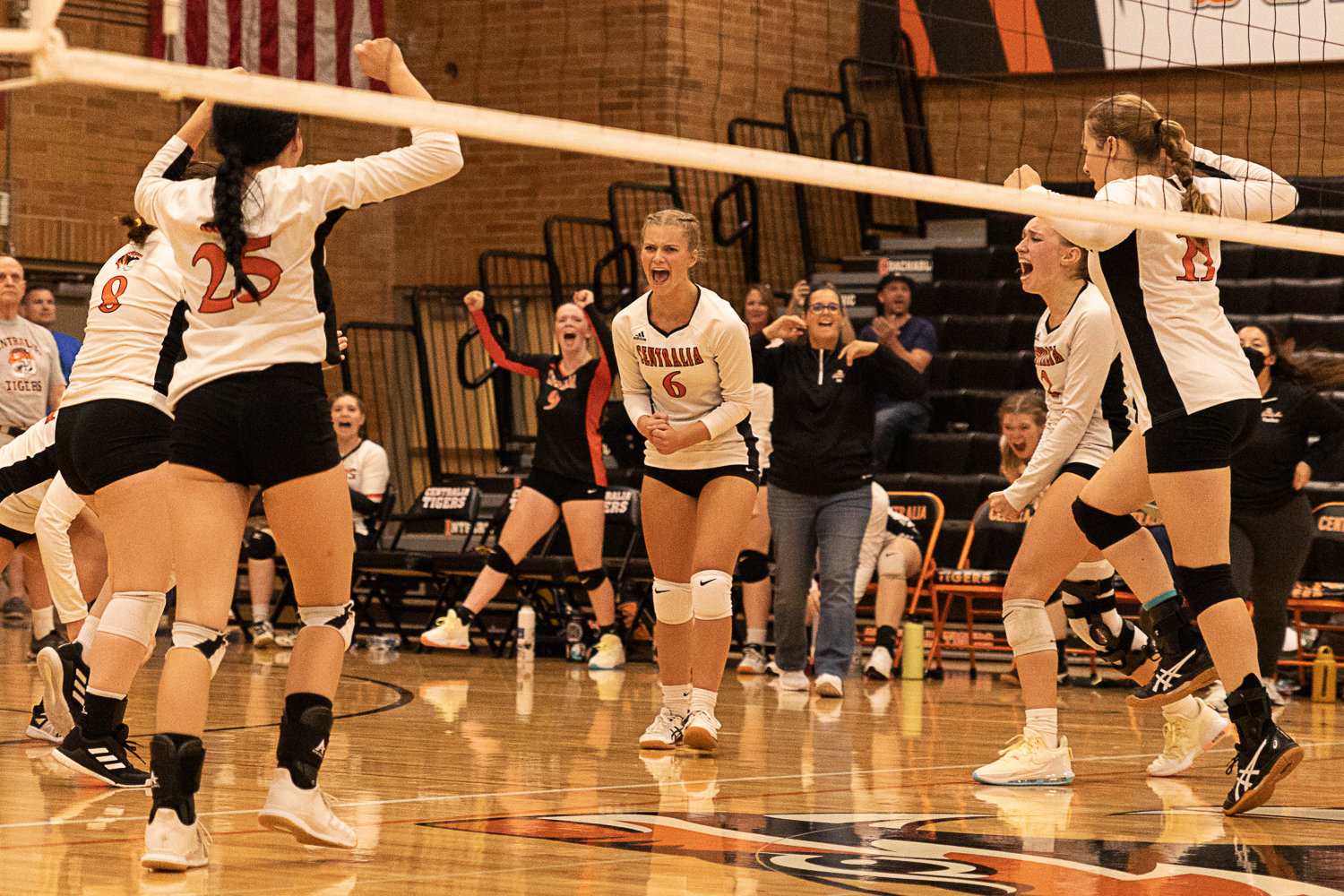 The Centralia volleyball team celebrates winning a set against Heritage Sept. 8.