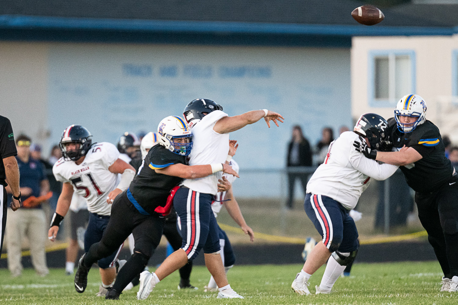 Black Hills quarterback Jaxsen Beck is hit as he throws by Rochester's Jaden Nichols Sept. 16 in the Wolves 34-14 win.