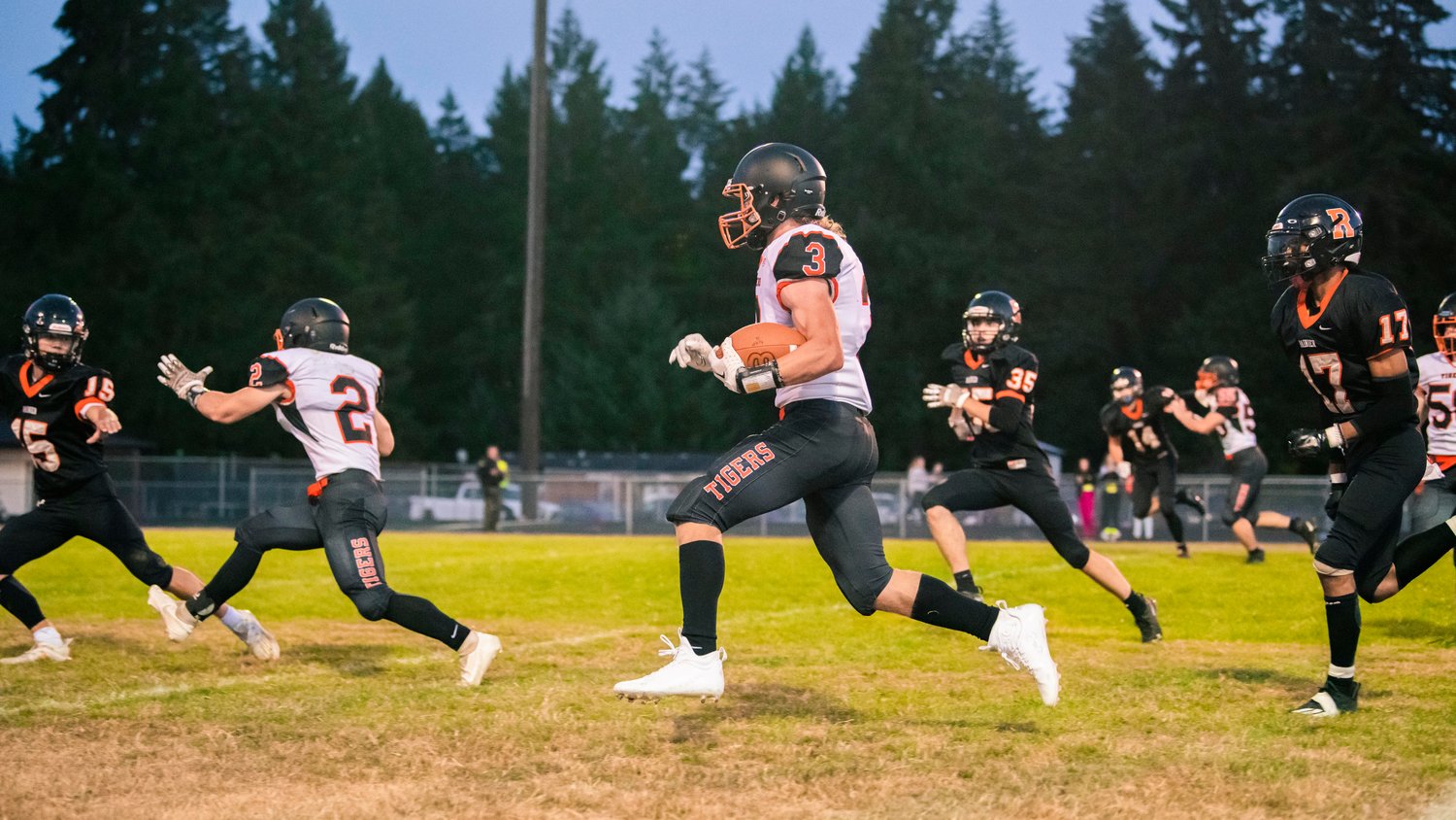 Napavine senior Max O’Neill (3) looks upfield before finding the endzone during a game Friday night in Rainier.
