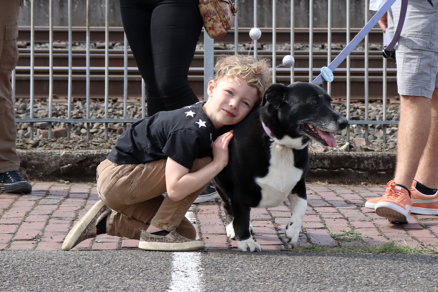 Six-year-old Emmett hugs his dog, Charlie, during the Chehalis Flying Saucer Party at the Lewis County Historical Museum on Saturday.