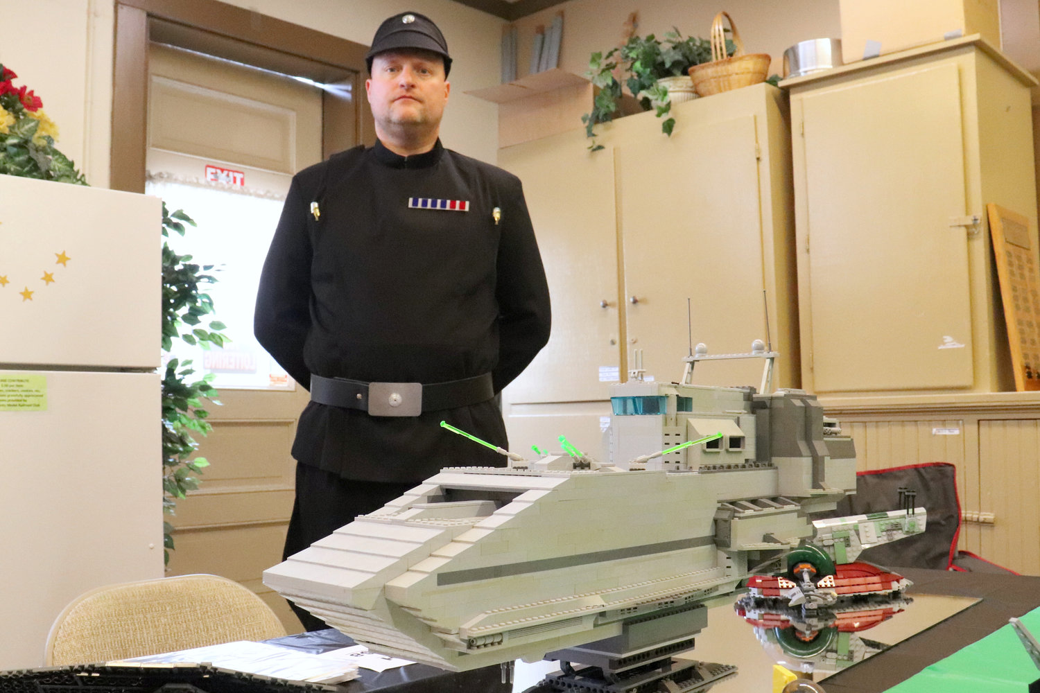 Steve Kross, dressed as a ANH staff officer, stands behind his LEGO creation in the Lewis County Historical Museum during the Chehalis Flying Saucer Party on Saturday.