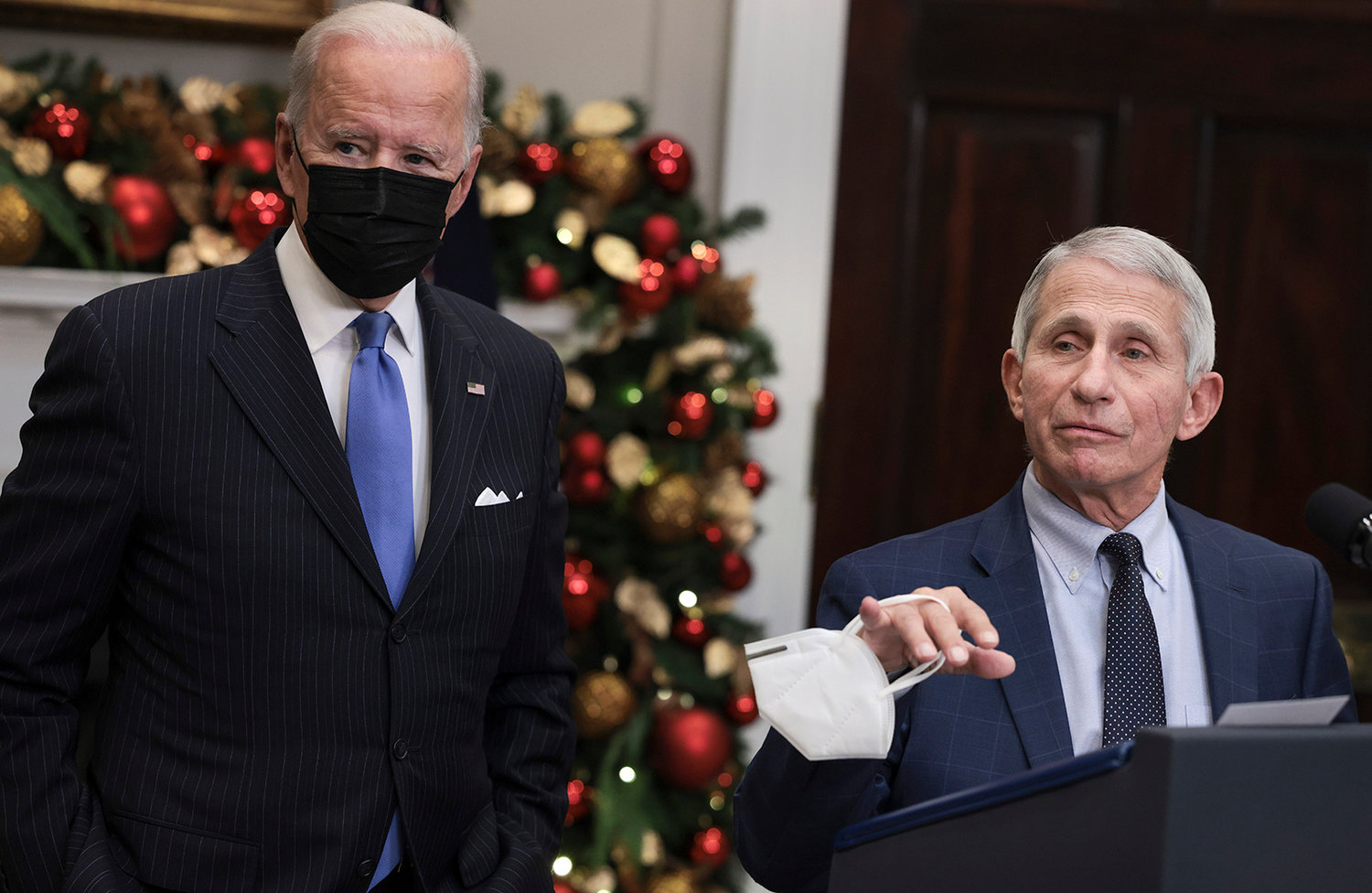Anthony Fauci (right), Director of the National Institute of Allergy and Infectious Diseases and Chief Medical Advisor to the President, speaks alongside U.S. President Joe Biden as he delivers remarks on the Omicron COVID-19 variant following a meeting of the COVID-19 response team at the White House on Nov. 29, 2021, in Washington, DC. (Anna Moneymaker/Getty Images/TNS)