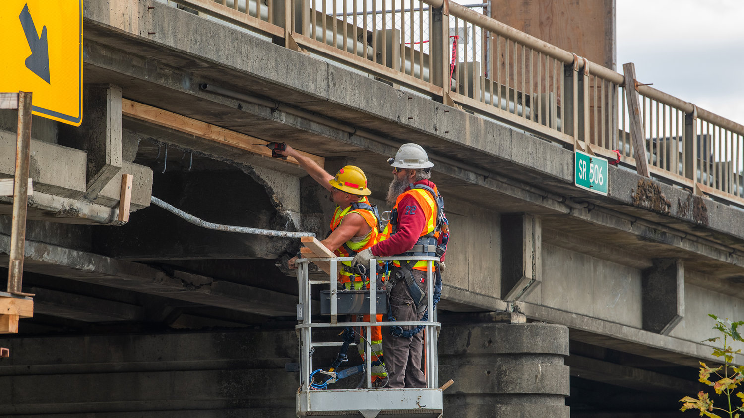 Wood and drills are used on the state Route 506 overpass to Interstate 5 after it was struck on Thursday closing Interstate 5 northbound causing a diversion in traffic.