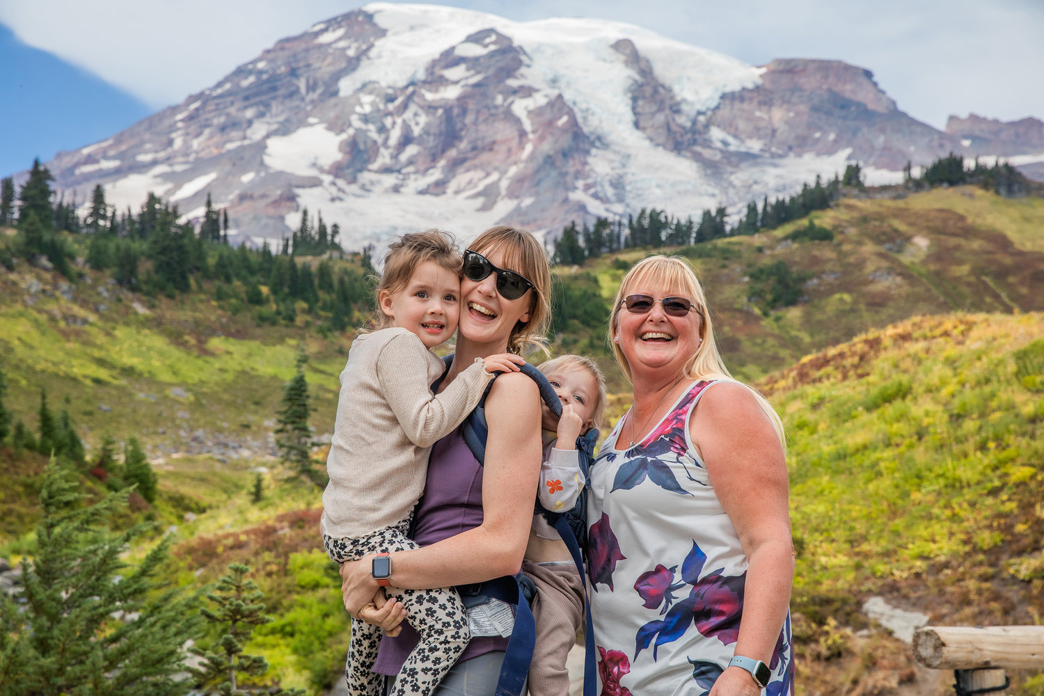 Visitors smile while posing for a photo in Paradise at Mount Rainier on Wednesday near Ashford.