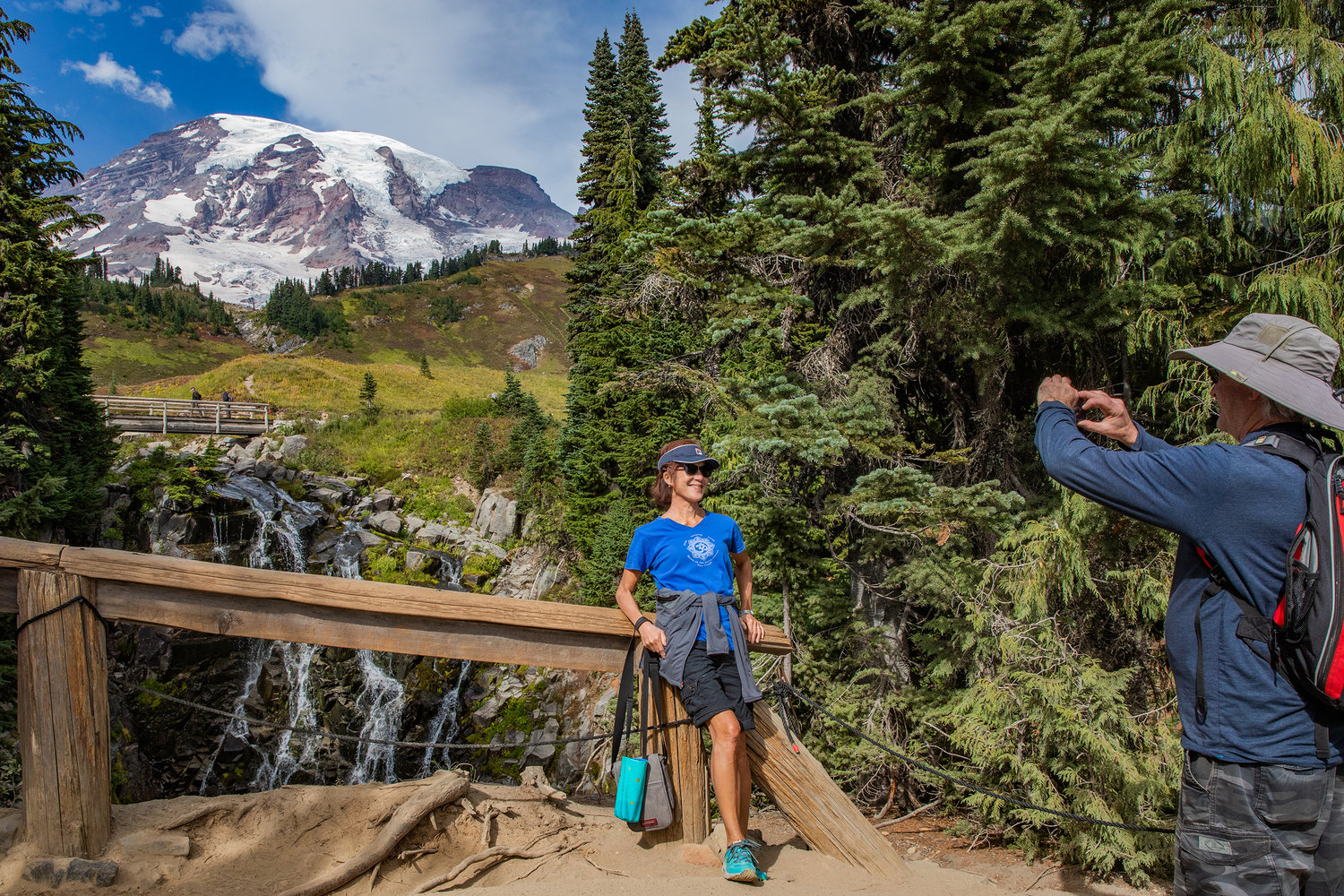Visitors pose and take photos in front of Myrtle Falls as Mount Rainier sets the backdrop on Wednesday near Ashford.