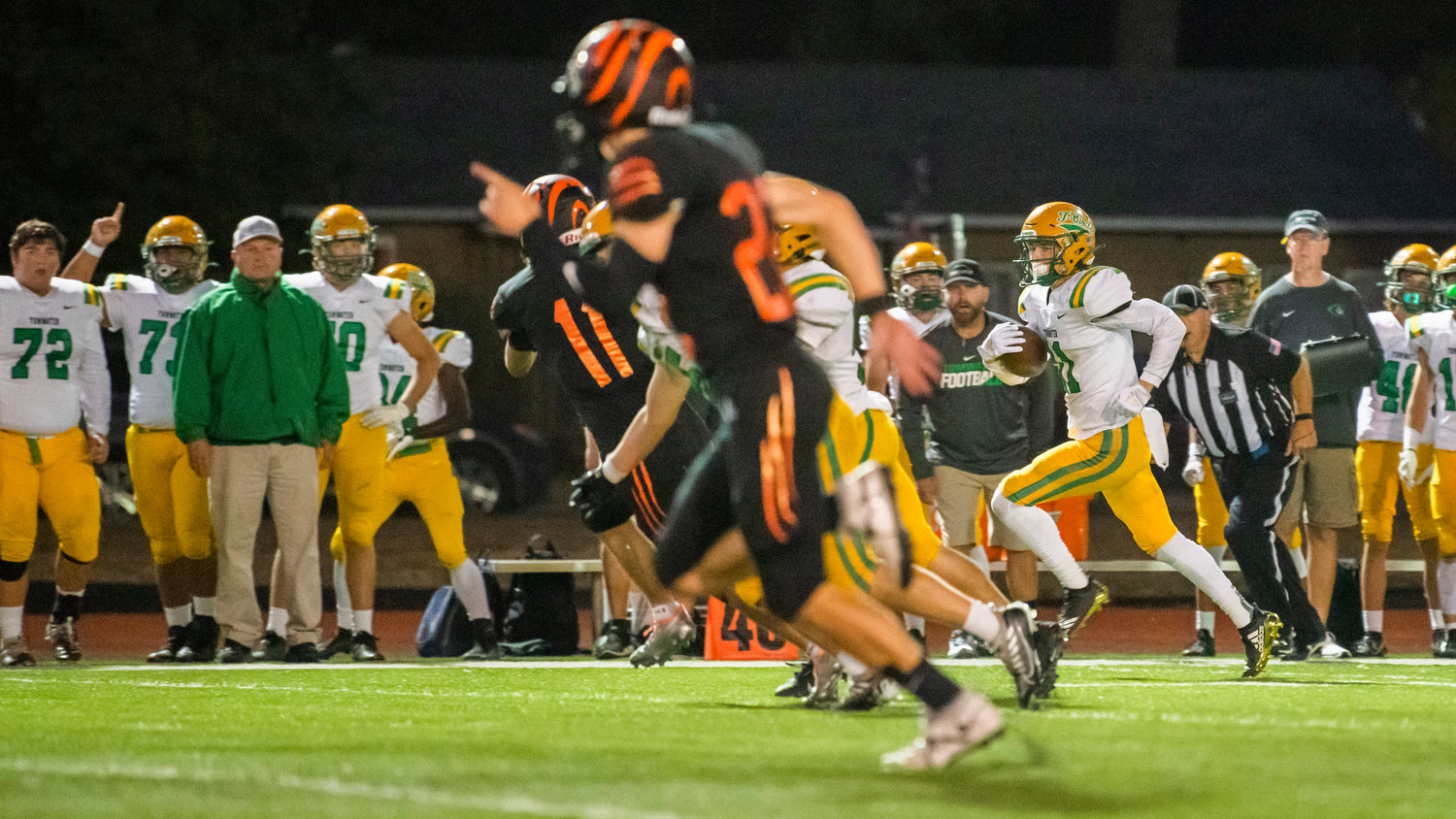 Tumwater senior Luke Reid (11) runs a kick back to the end zone during a game against Centralia Friday night.