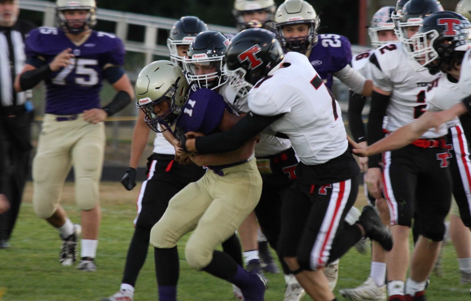 Tenino's Kysen Knox gets to Onalaska's Rodrigo Rodriguez for a stop during the Beavers' 40-6 win over the Loggers in Onalaska on Sept. 23.