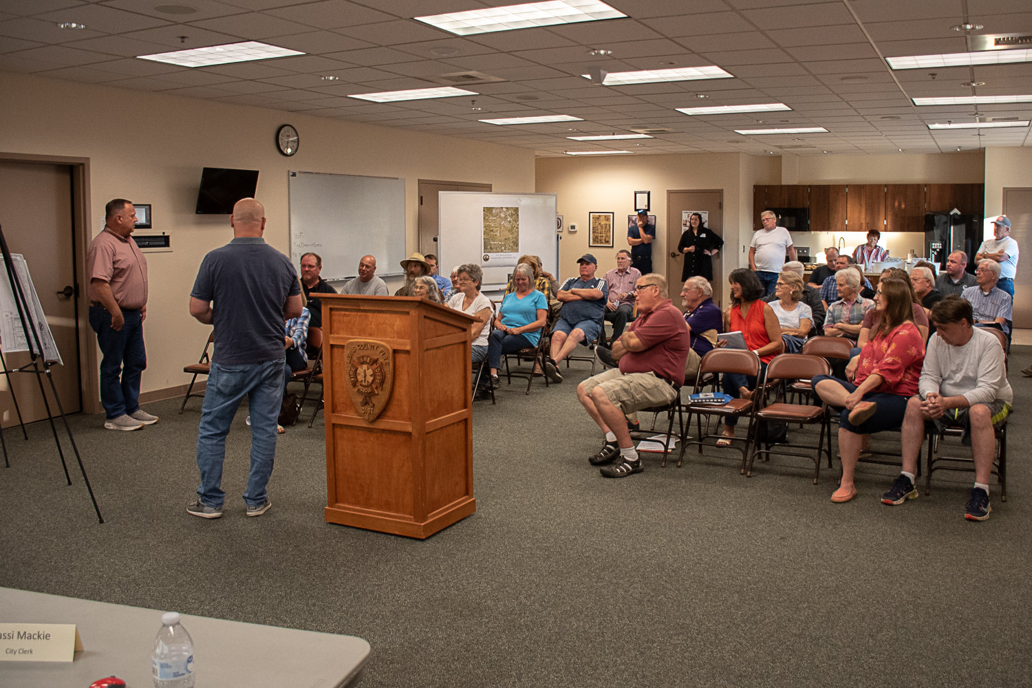 K&W Properties LLC Owner Karl Werner (left) and Project Engineer Bob Balmelli (right) stand in front and begin to field questions and concerns being raised by residents in the area.