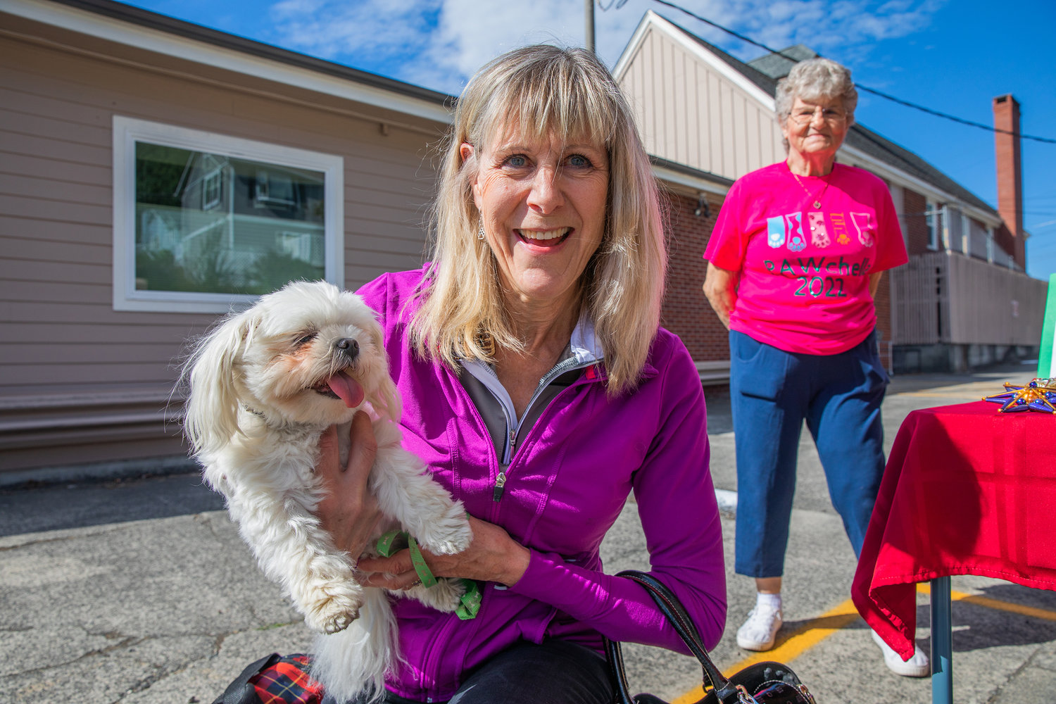 Valerie Sullivan, of Centralia, smiles while holding Cricket, a Maltese, during the “Blessing of the Animals” at Chehalis United Methodist Church on Saturday.