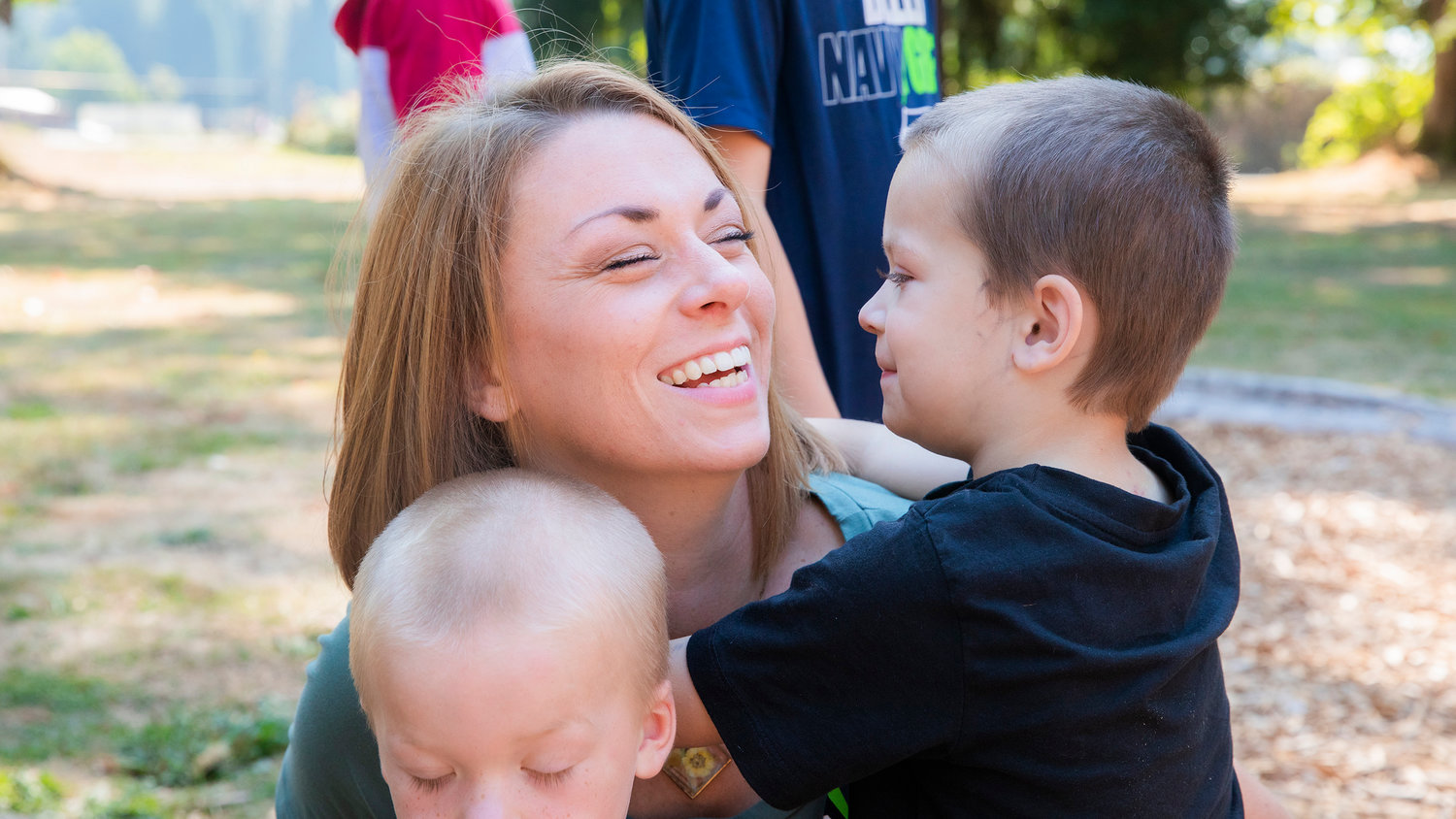 Rena Kreis smiles after receiving a kiss from Titus Sickles, 4, Tuesday afternoon at Kemp Olson Memorial Park in Toledo.